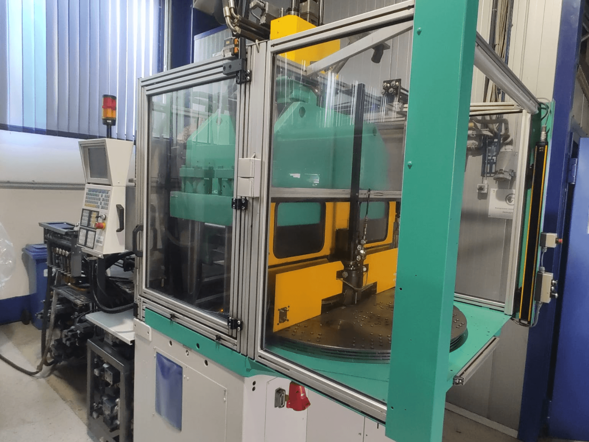 Arburg 1200 TS 800-60-350 vertical injection moulding machine, front view showcasing the control panel and safety enclosure.