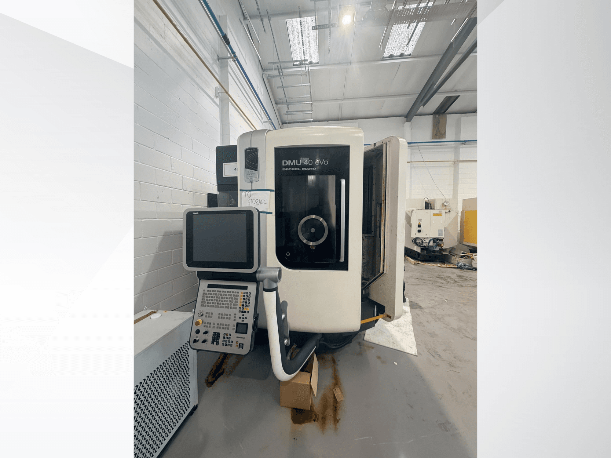DMG DMU 40 evo vertical machining center front view, showing control panel and spindle area, with workspace in background.