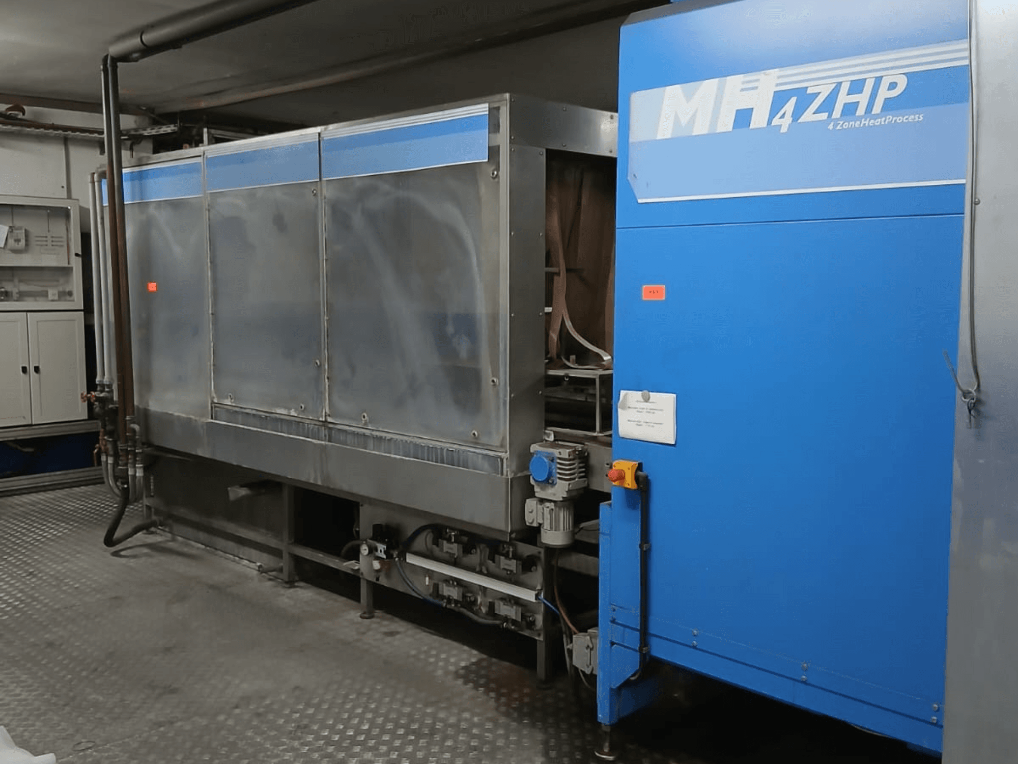 Industrial MH 4ZHP machine in a side view, showing stainless steel structure and blue panel with control elements.