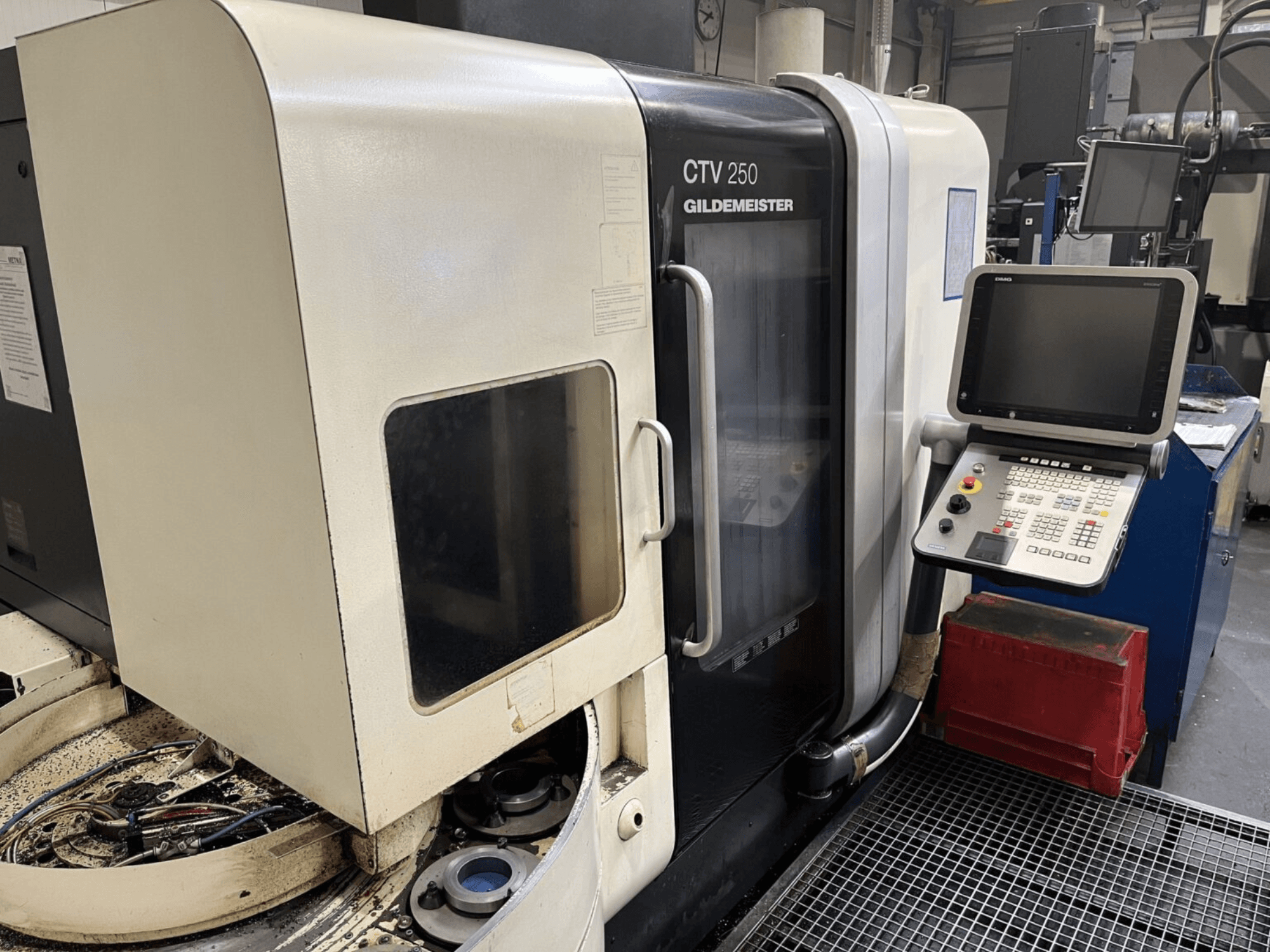 Vertical turning machine DMG CTV-250 viewed from the front, showcasing control panel and work area with tools.