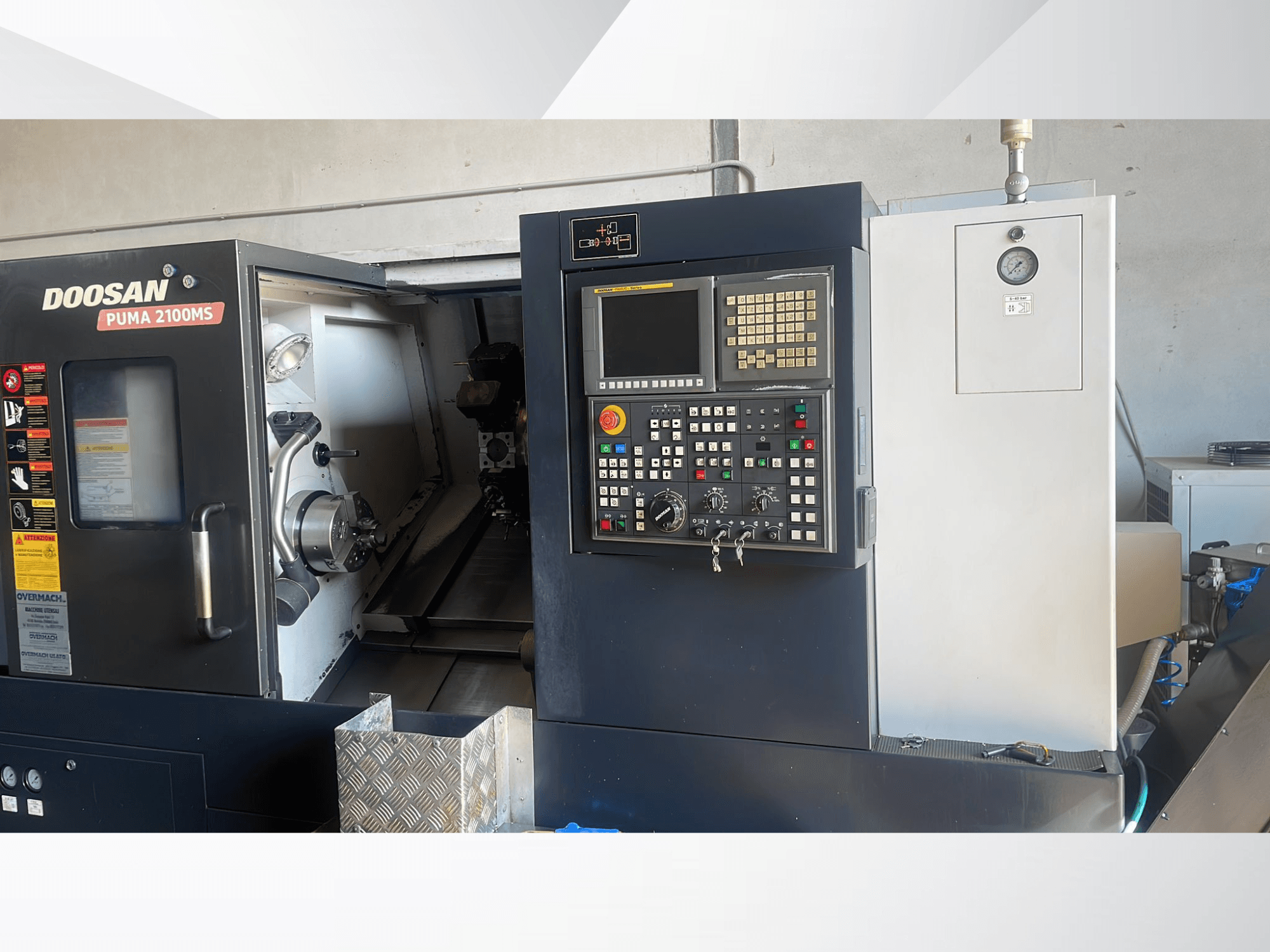 DOOSAN PUMA 2100MS horizontal turning machine front view, showing control panel, spindle, and cutting tools inside the chamber.