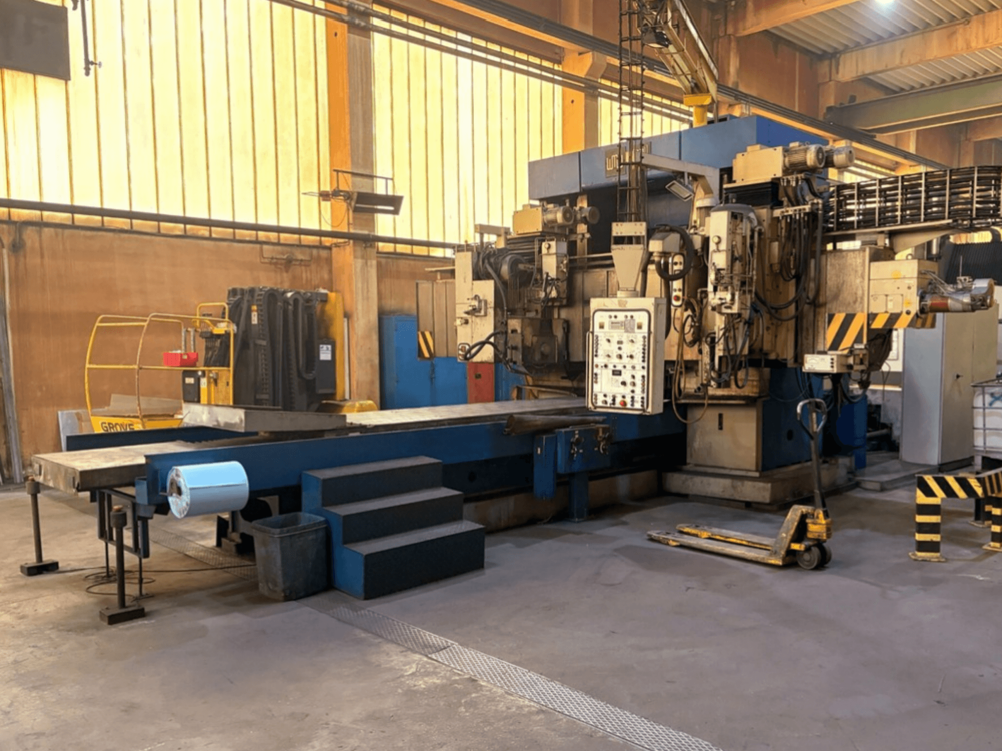 WMW-Heckert SZ10-10-03 surface grinding machine in factory setting; side view showing control panel and worktable.