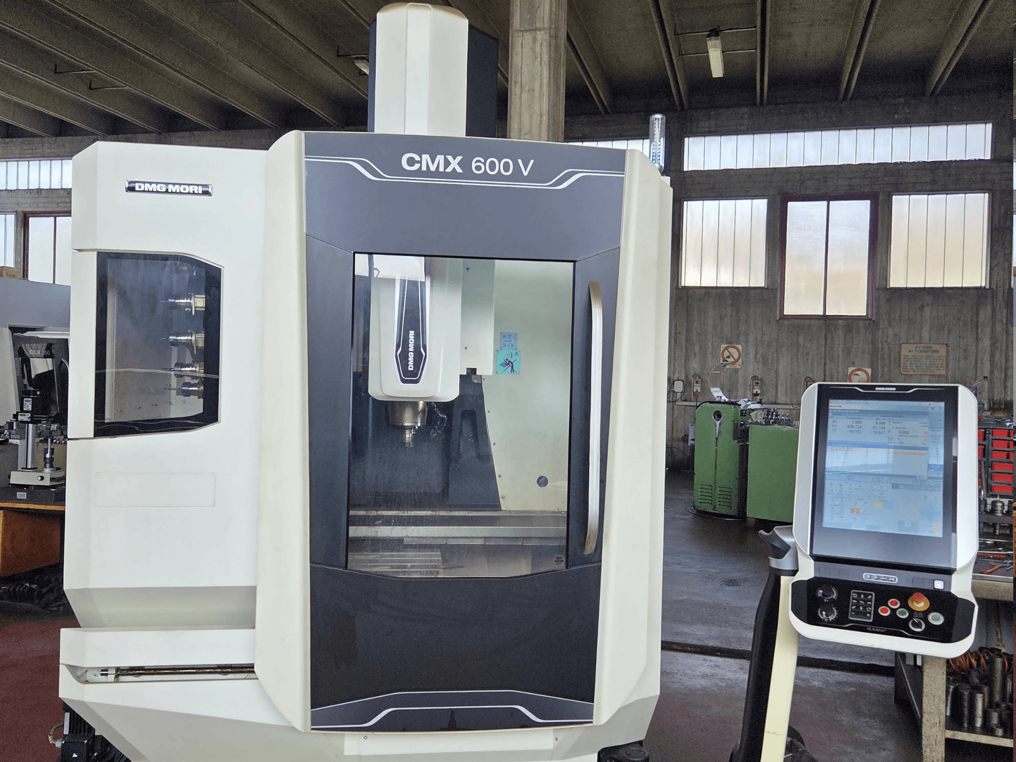 DMG MORI CMX 600V vertical machining center in front view, showcasing control panel and spindle area detail.