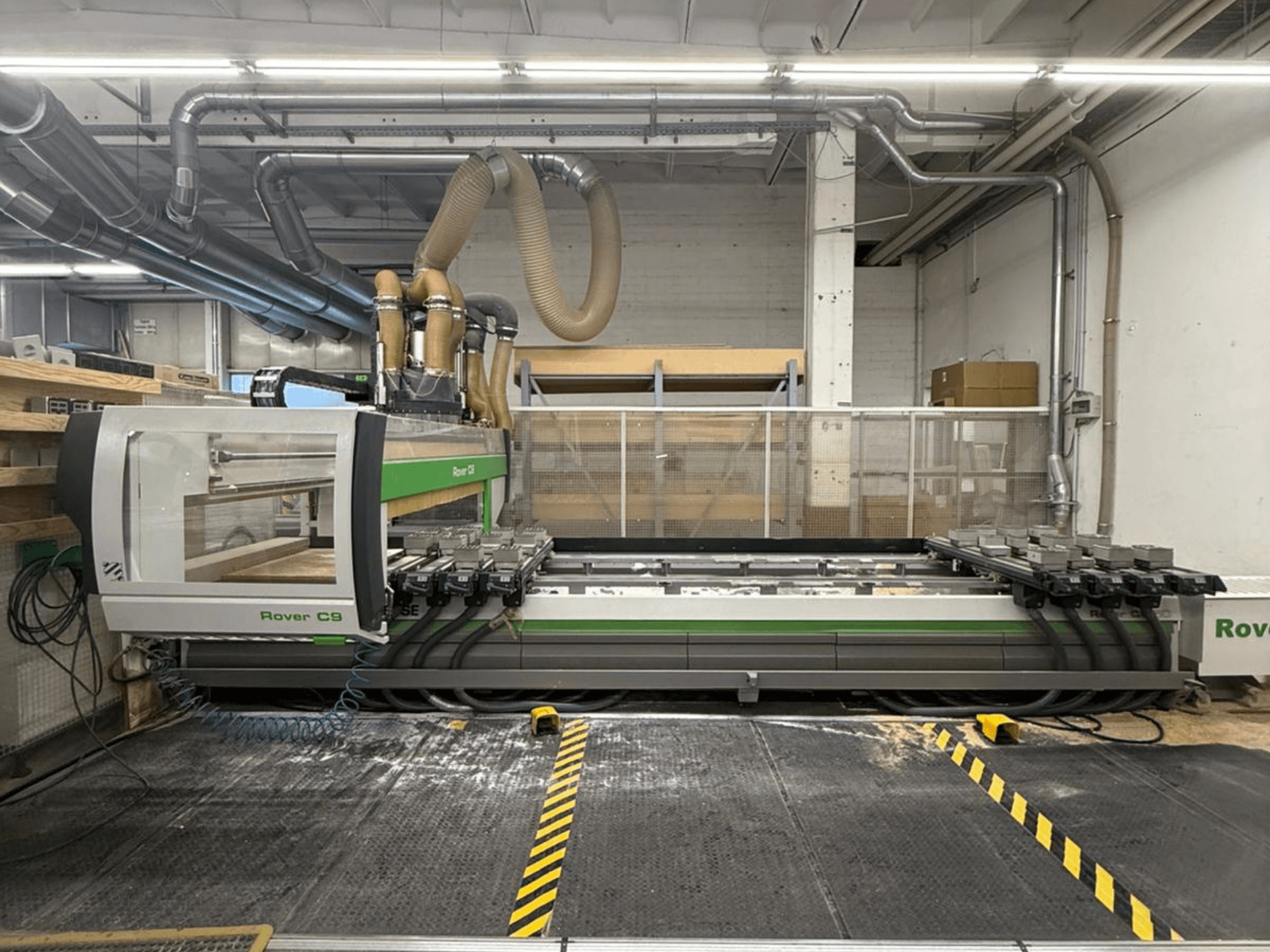 Rover C9 CNC machine in a workshop, front view, featuring multiple cutting heads and visible dust extraction system.