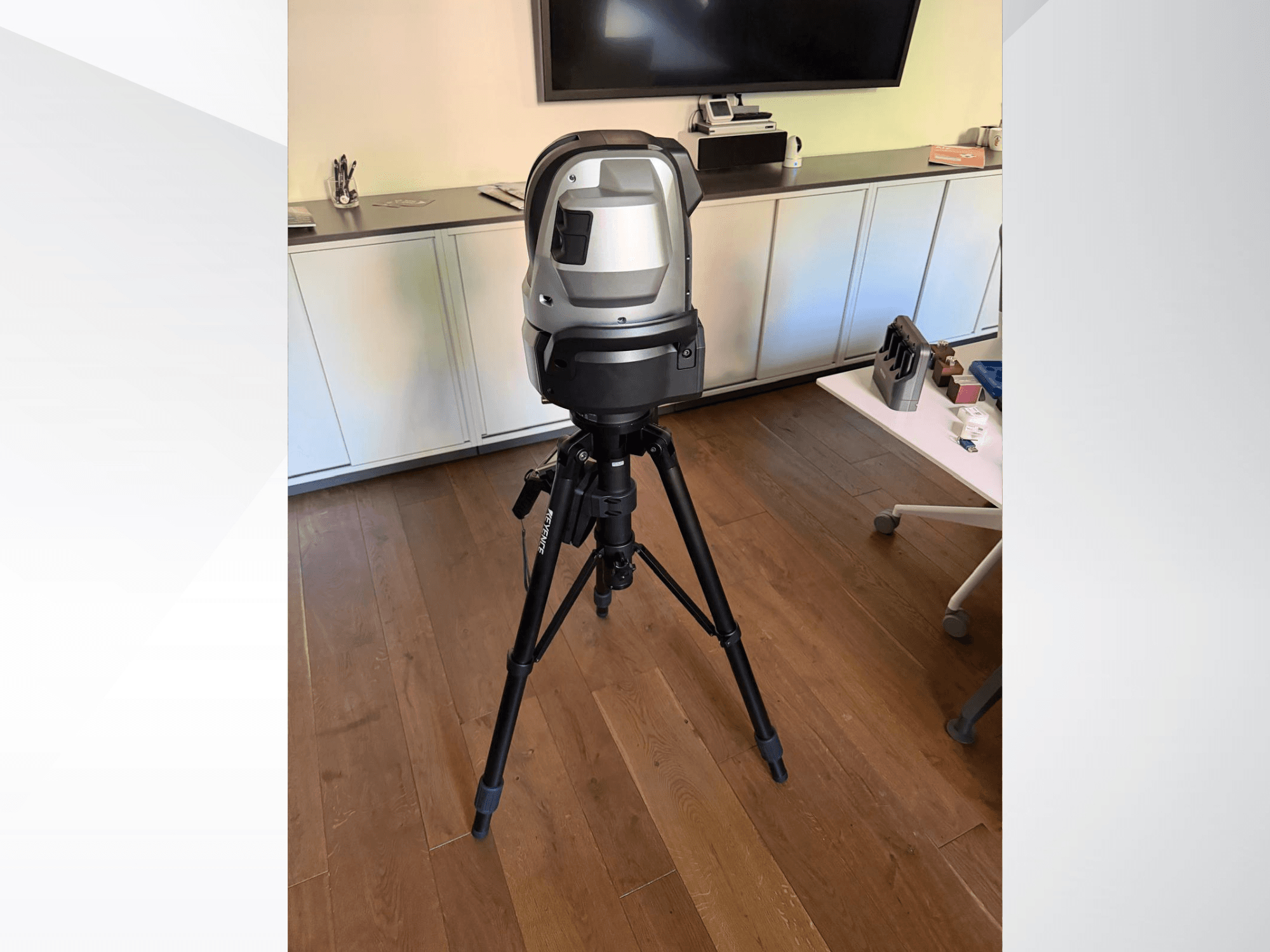 KEYENCE WM c3000 Coordinate Measuring Machine viewed from the front, mounted on a tripod with a sleek design and control interface.