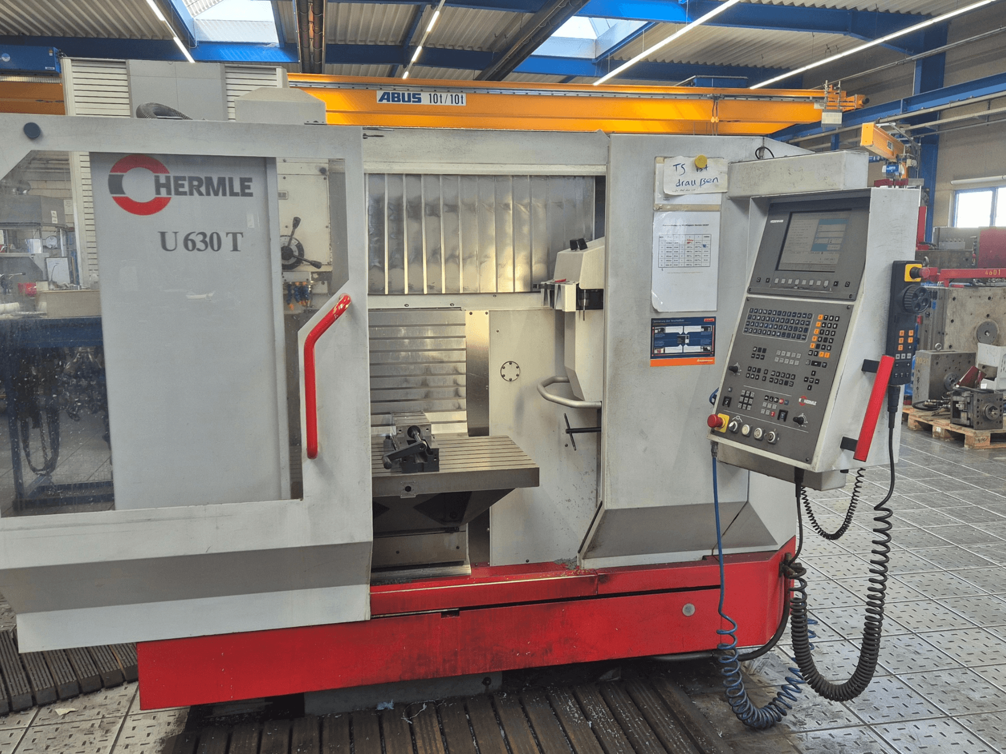 HERMLE U 630 T vertical machining center in front view, featuring control panel, worktable, and safety guard.