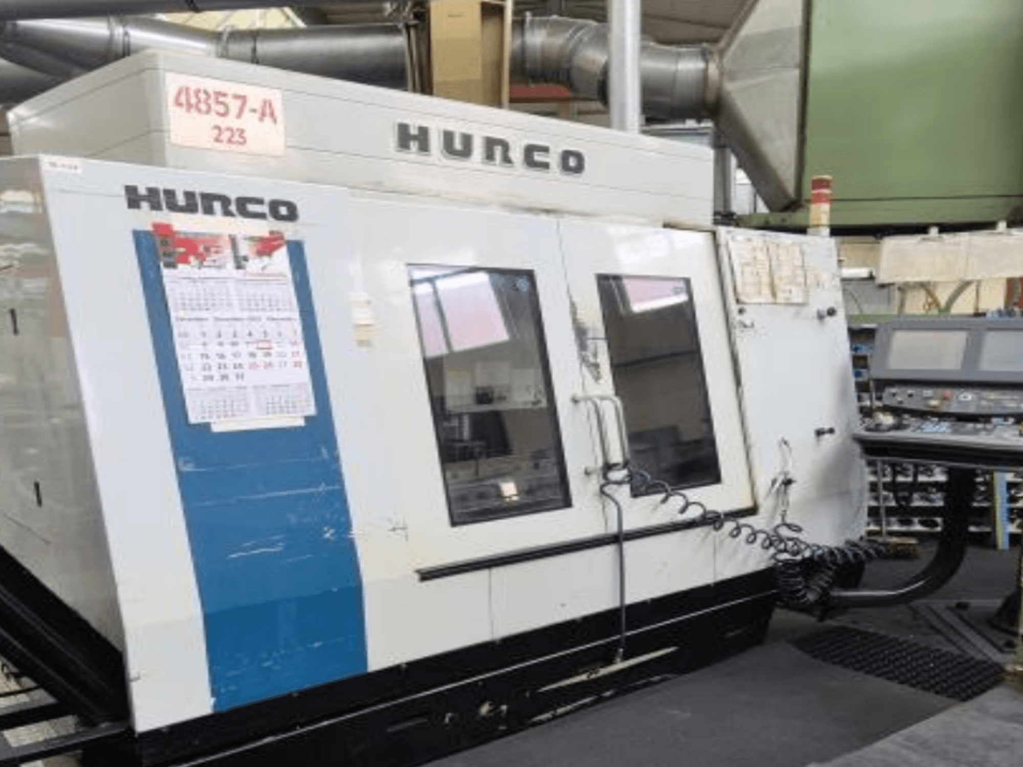 Hurco VMX 42 vertical machining center in front view, featuring control panel, calendar, and metal exterior details.