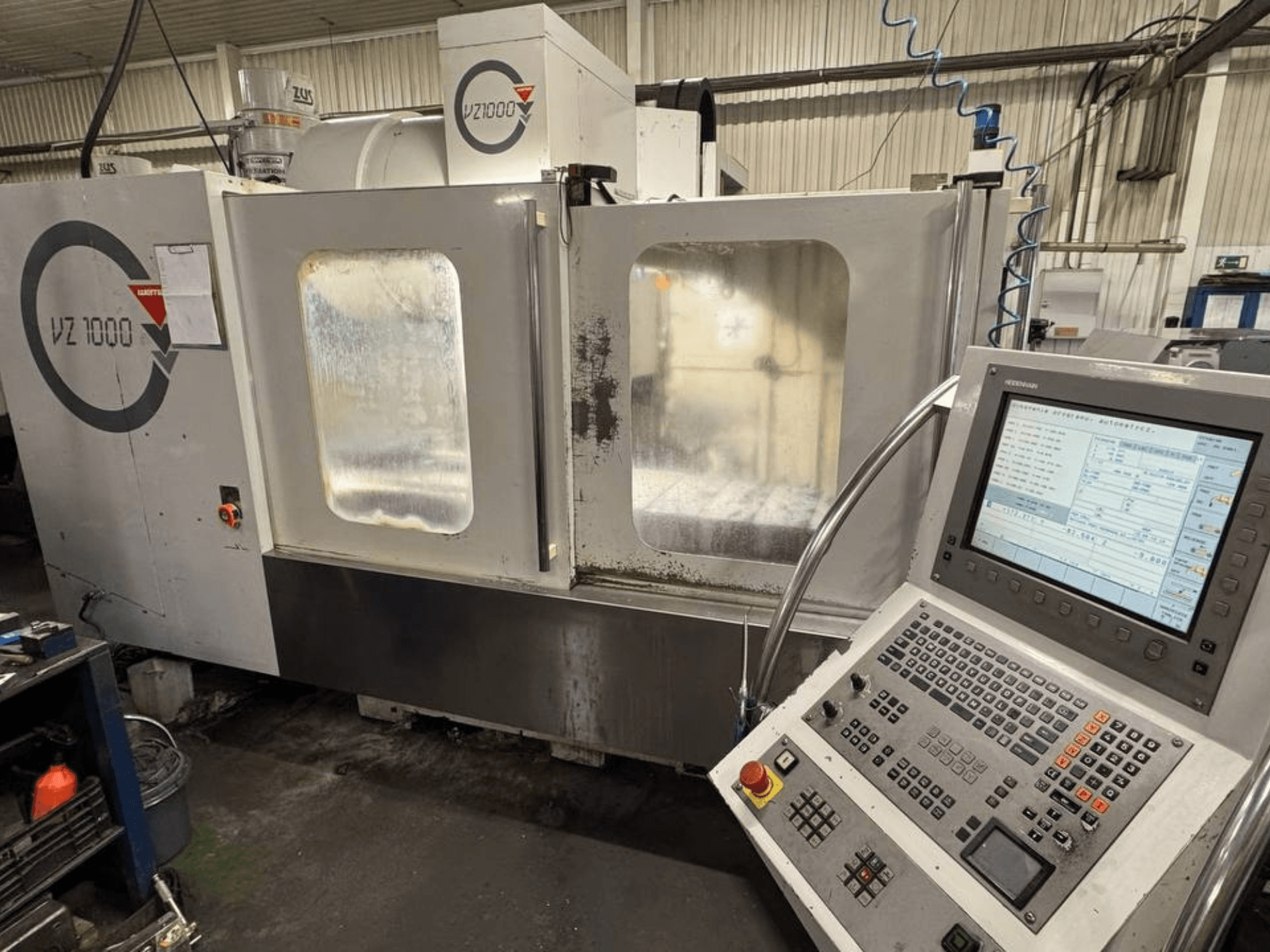 Front view of WEMAS VZ 1000 vertical machining center, featuring control panel and transparent access doors.