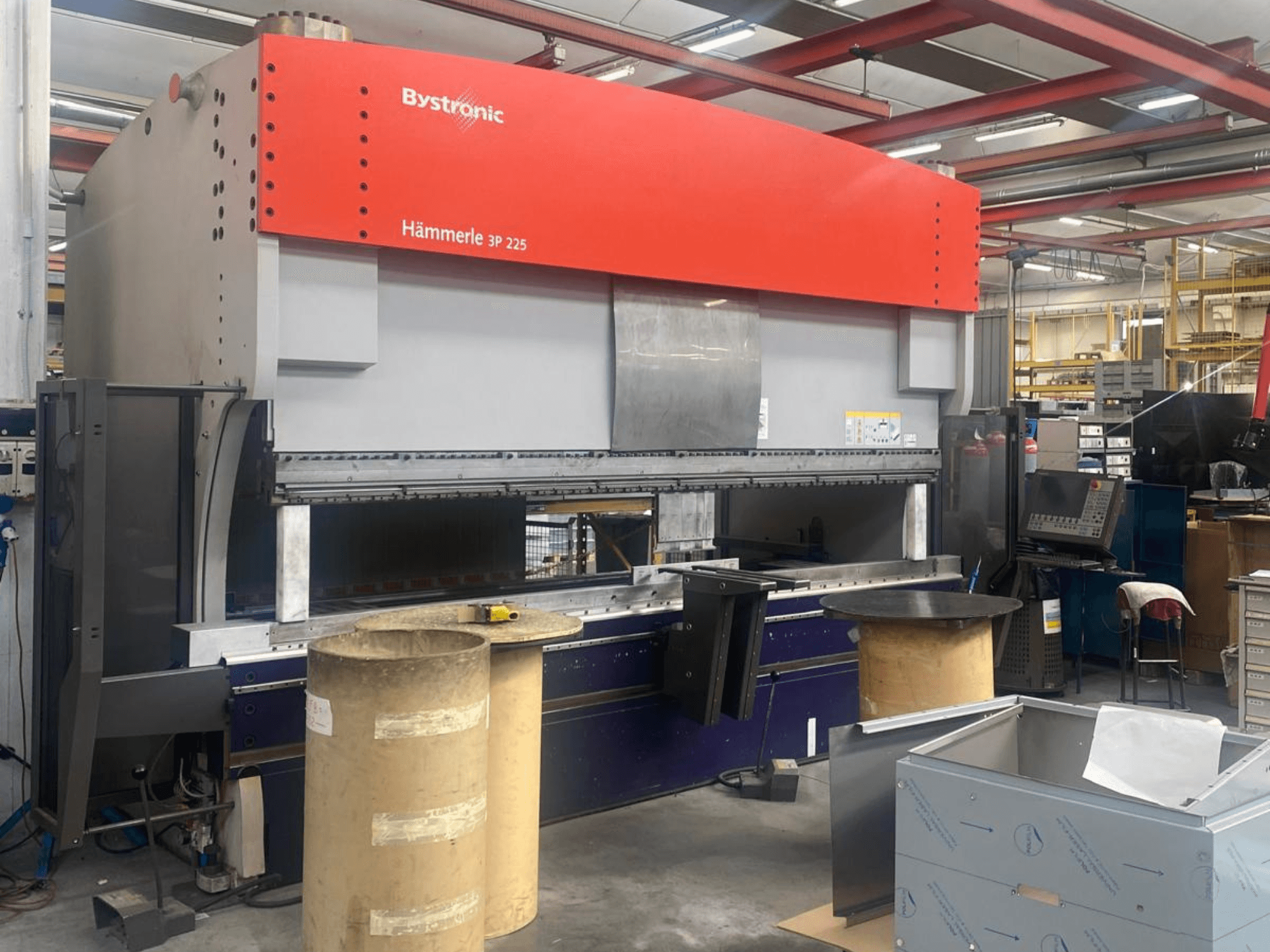 Bystronic Hammerle 225 3P press brake in a workshop, showing front view, large bending table, and surrounding machinery.