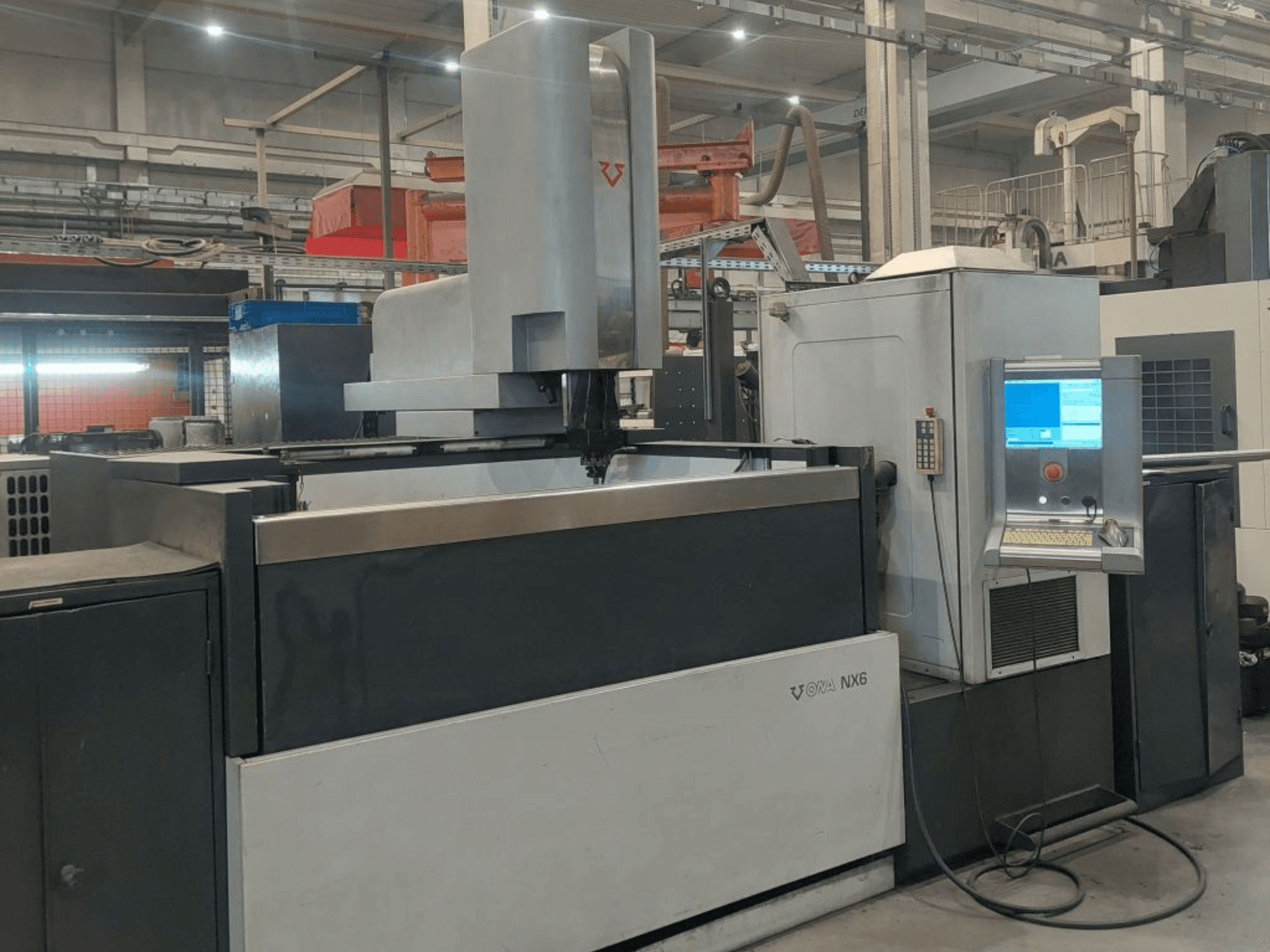 ONA NX6 Die-Sinking EDM Machine in a front view, featuring a control panel and a large working area for precision machining.