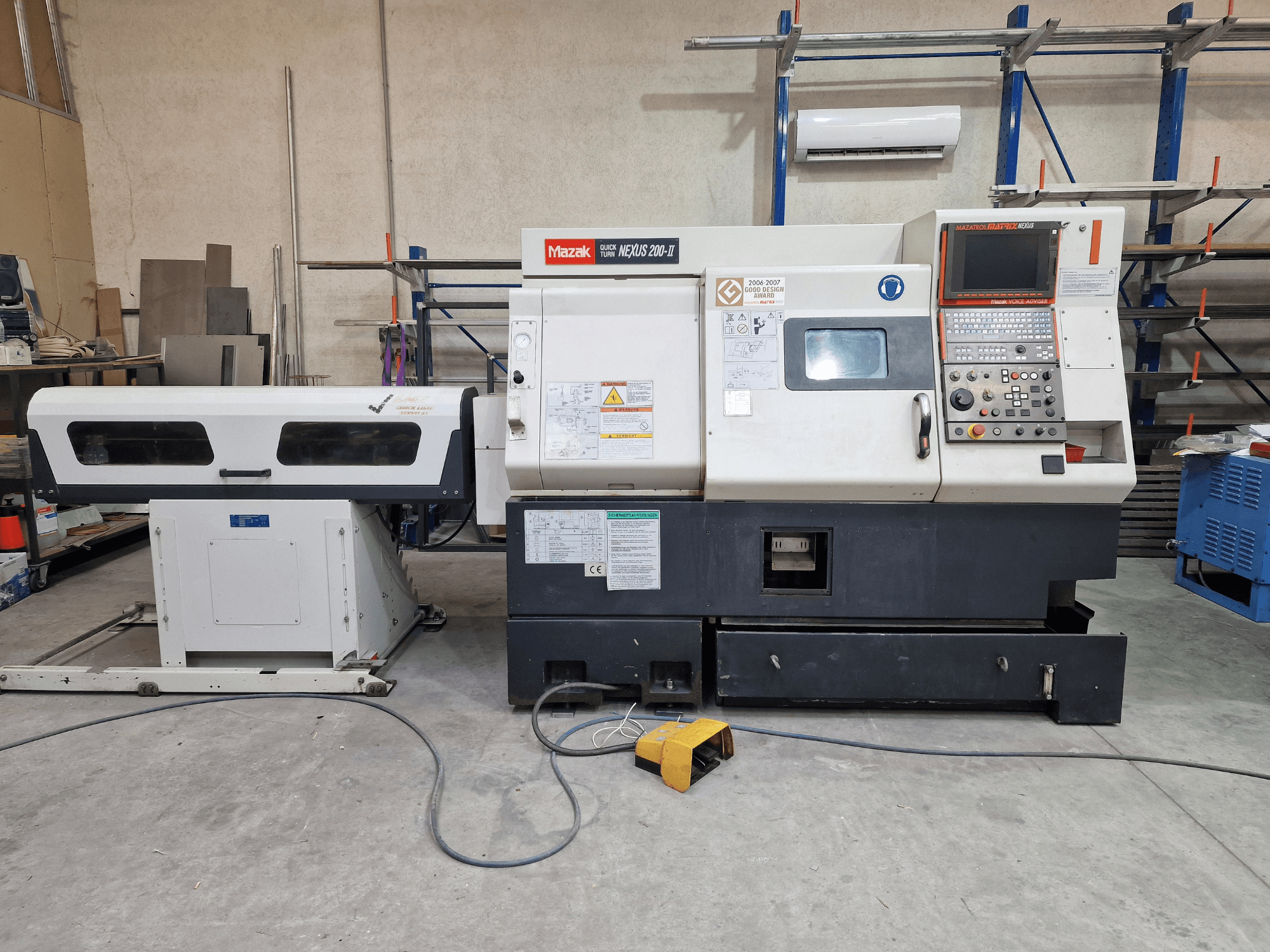 Mazak QuickTurn Nexus 200 horizontal turning machine, side view, showcasing control panel, spindle, and chip tray.