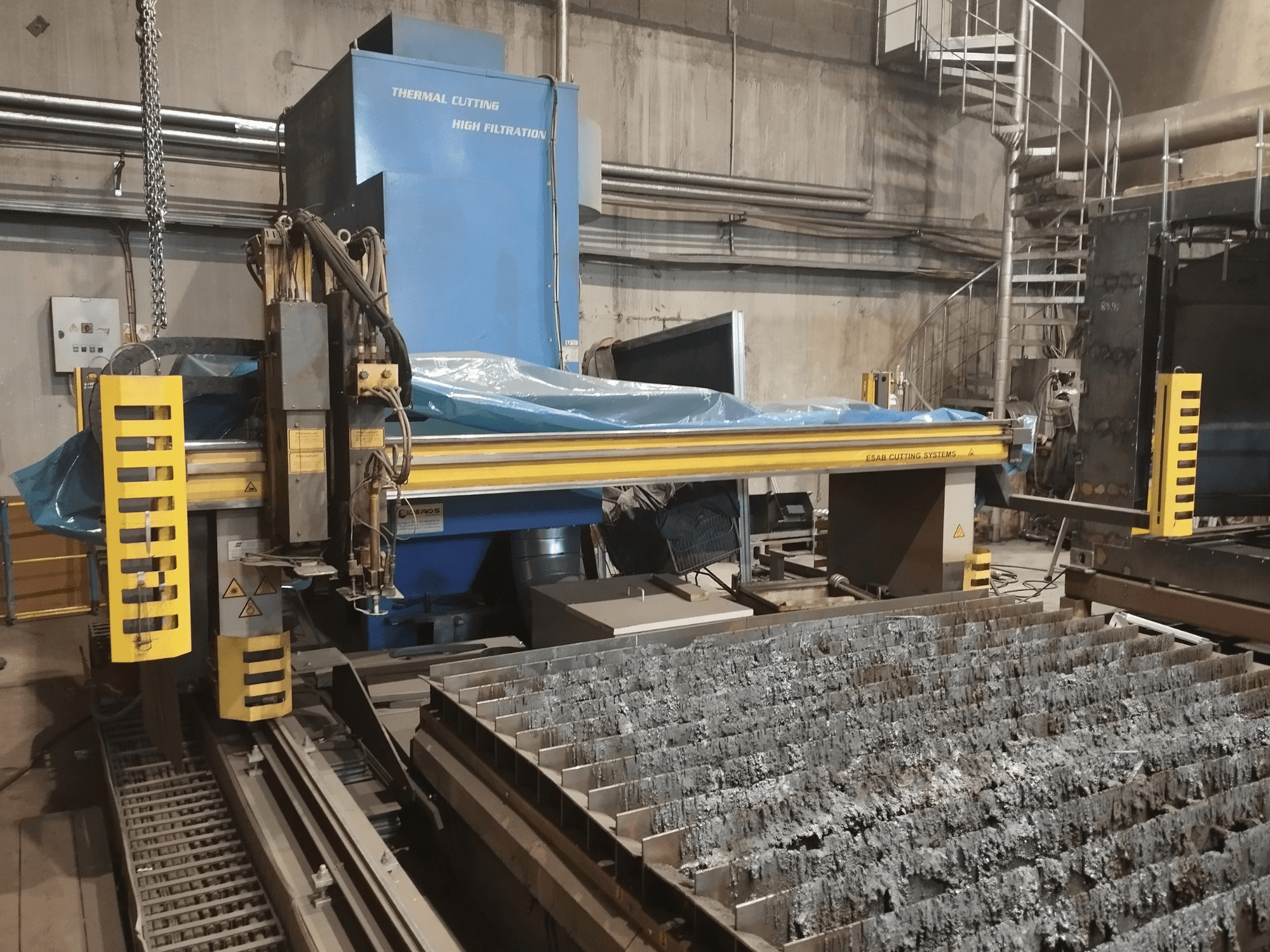 ESAB Combirex DX3500 Oxy plasma cutting machine, front view, with yellow safety features and a metal cutting table.