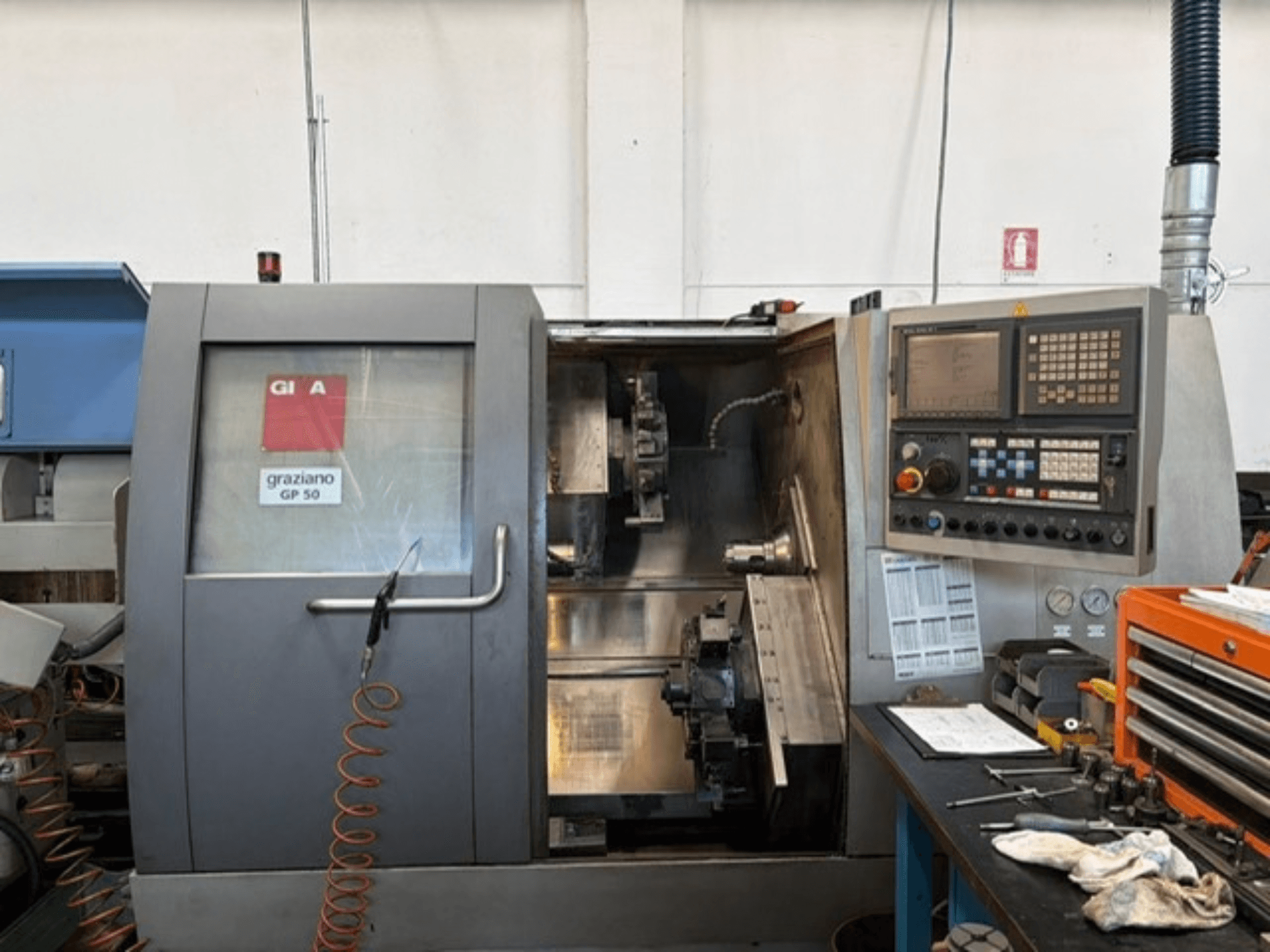 Gildemeister GP 50 horizontal turning machine, front view, displaying control panel and open workspace with tools.