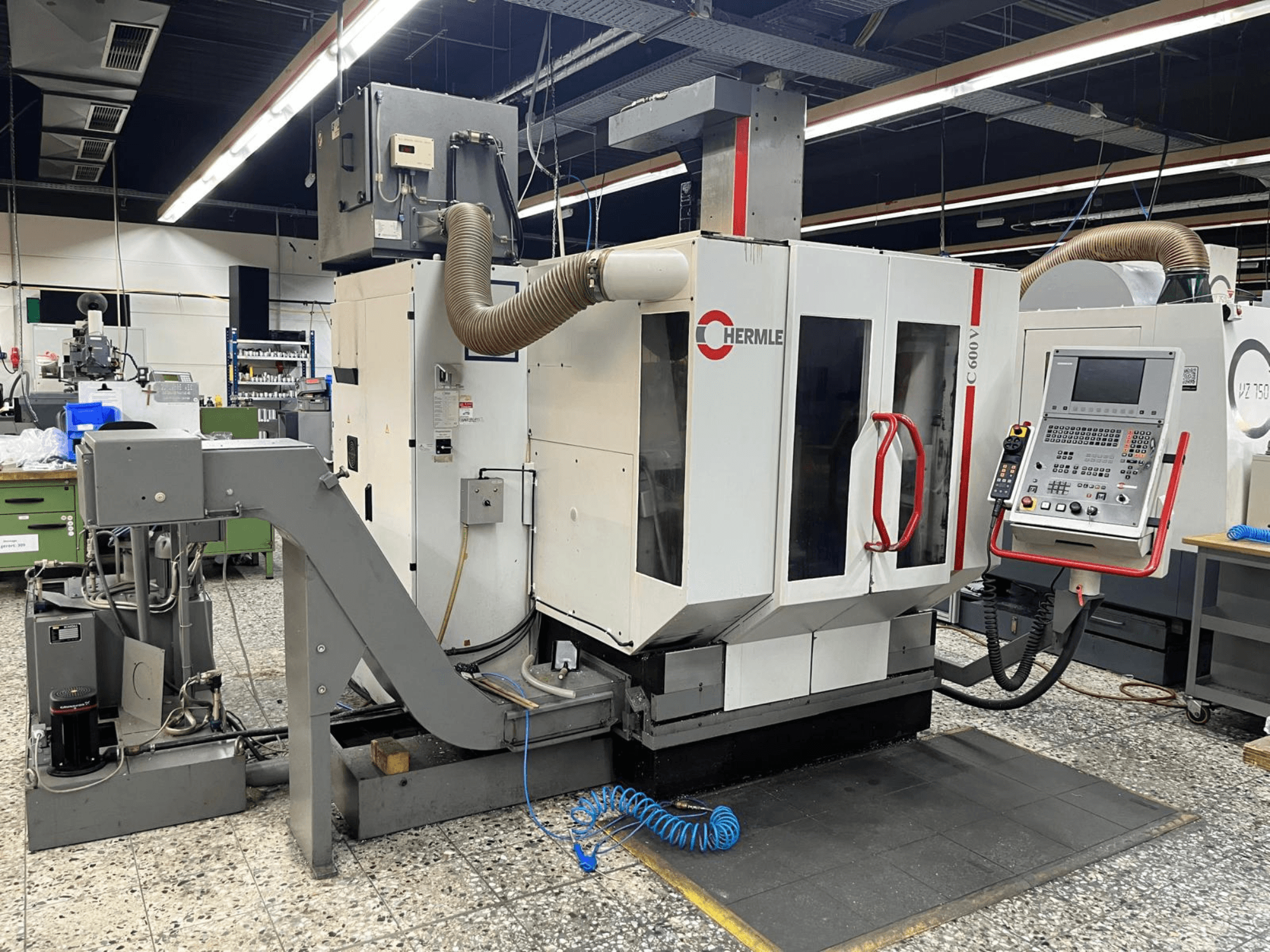 HERMLE C 600 V vertical machining centre in a workshop, front view showing control panel and ventilation features.