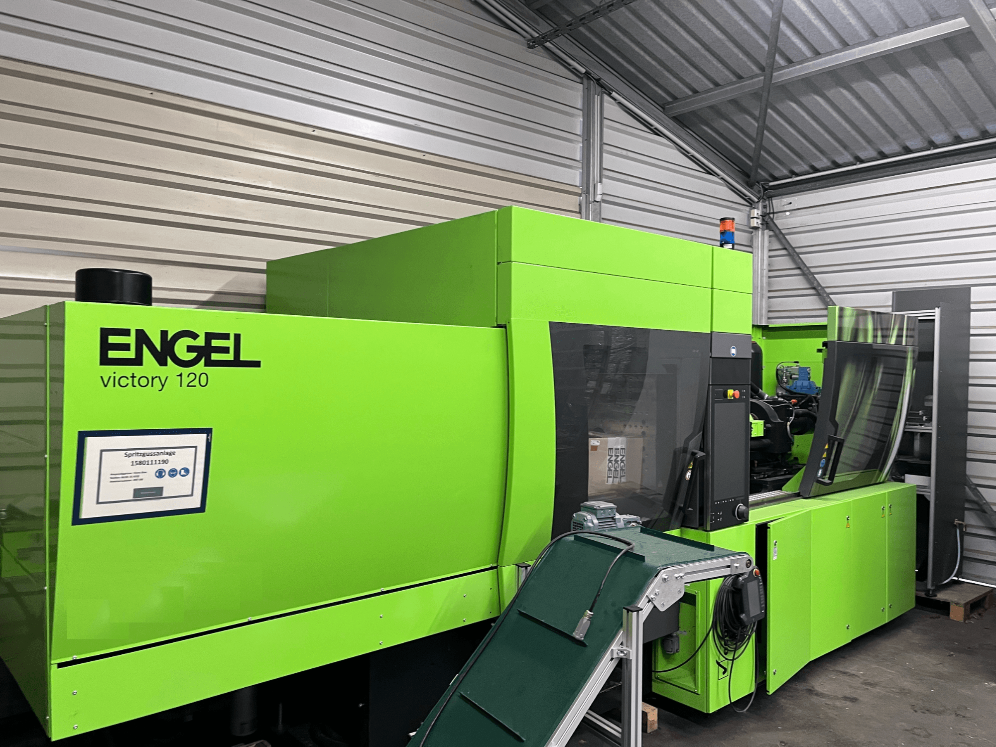 Green Engel Victory 120 BMG hydraulic injection moulding machine, front view showcasing control panel and machine components.