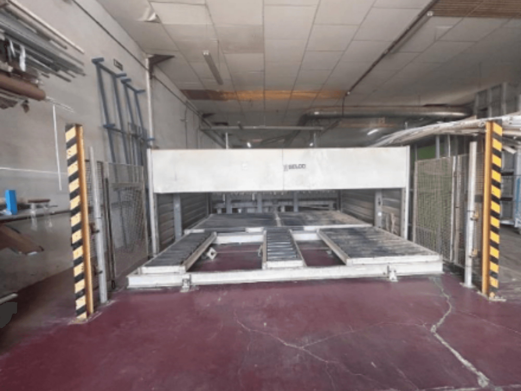 BIESSE Selco WNTR 600 panel saw from front view, featuring cutting table and safety barriers in an industrial setting.