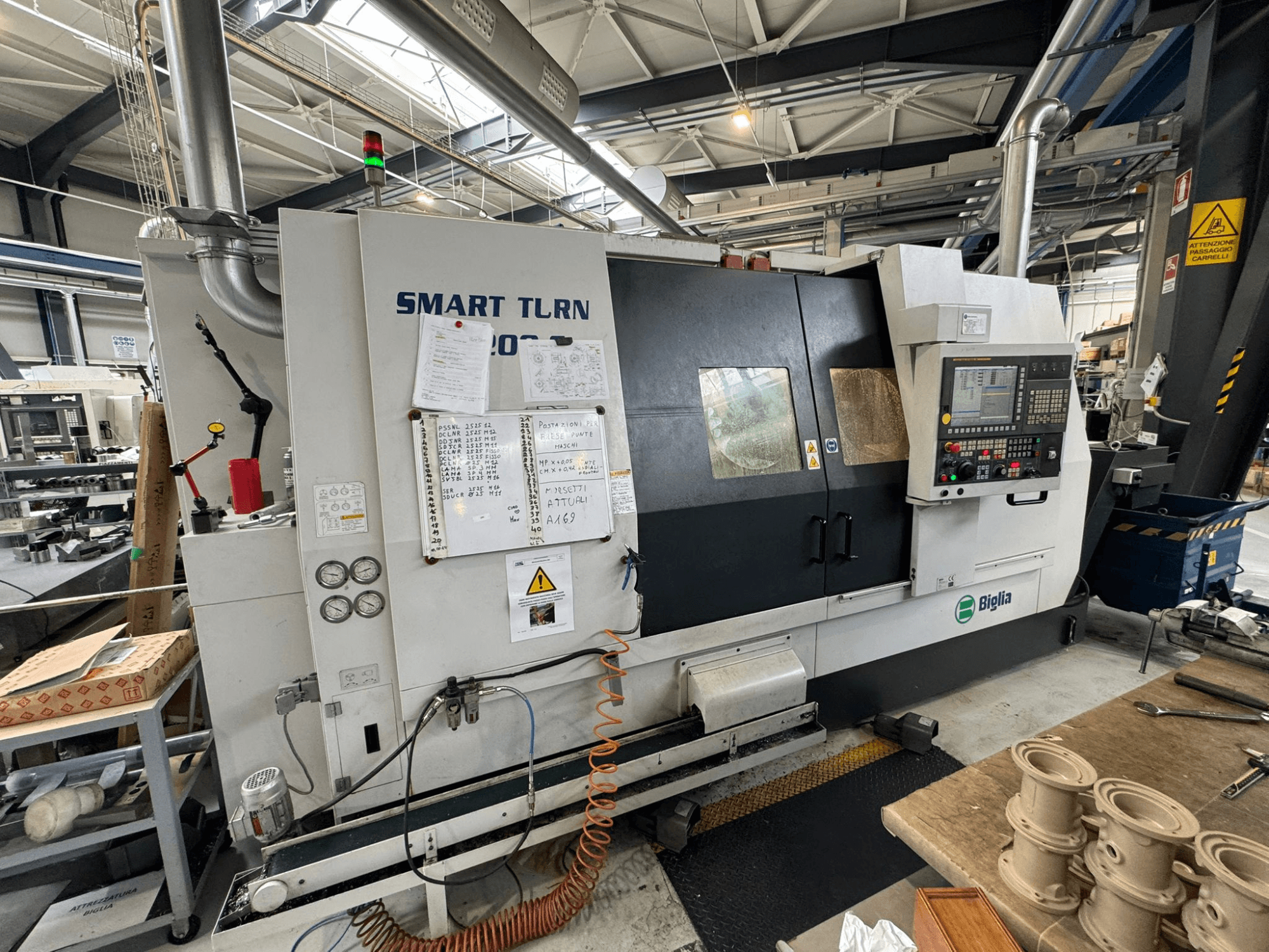 Biglia Smart Turn B1200S turn-mill centre in a workshop, featuring control panel, gauges, and safety indicators.