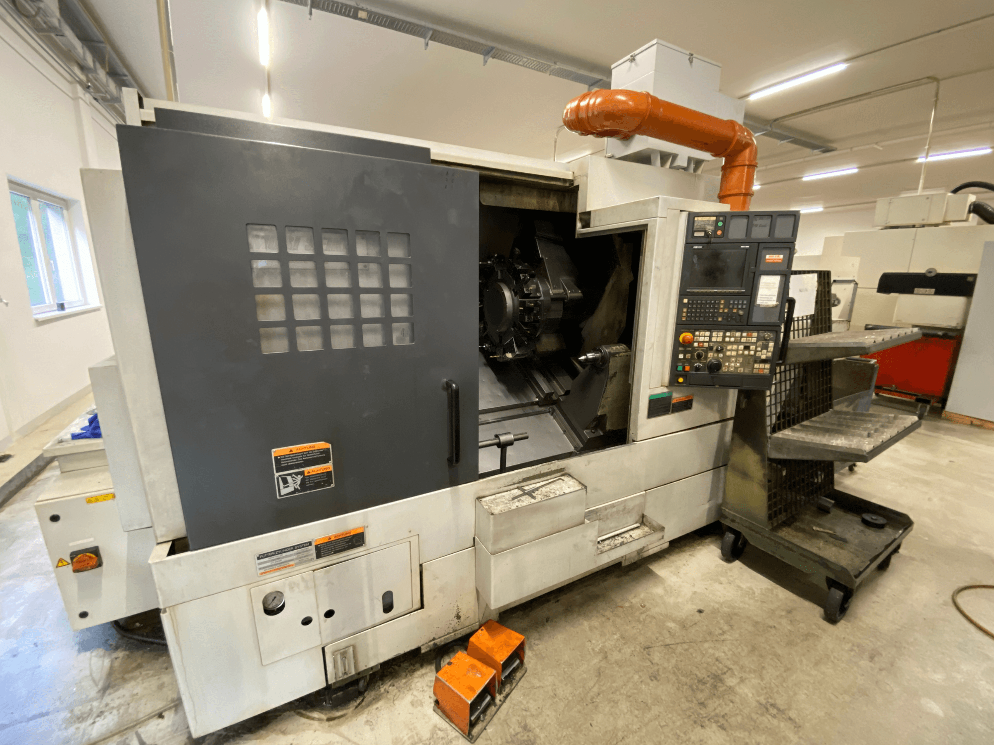 DMG Mori Seiki NL2500Y/700 turn-mill center, front view showing control panel and machine enclosure details.