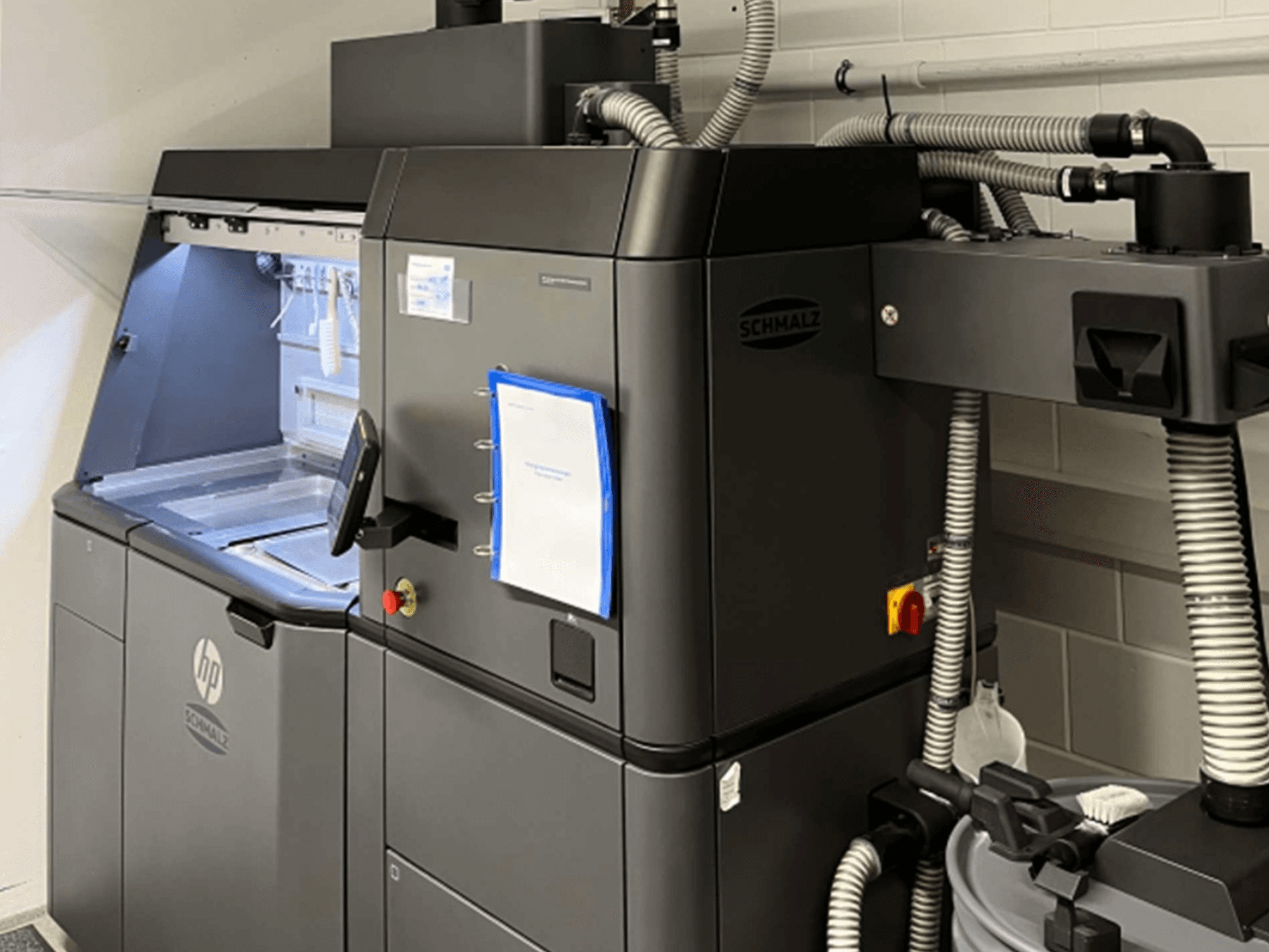 HP Jet Fusion 3D 4200 plastic 3D printer, side view, showcasing control panel and internal components.