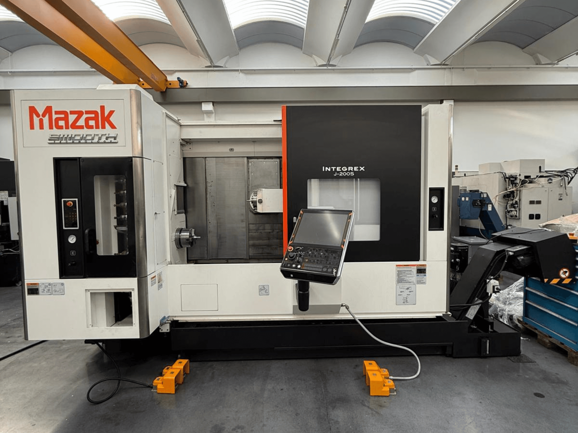 Mazak INTEGREX J-200 S mill-turn center in front view, featuring control panel and machining area, set on factory floor.