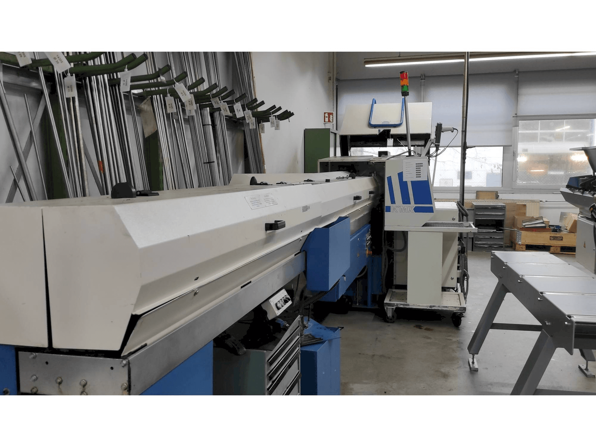 Left view of Manurhin KMX 226 with FMB bar loader machine