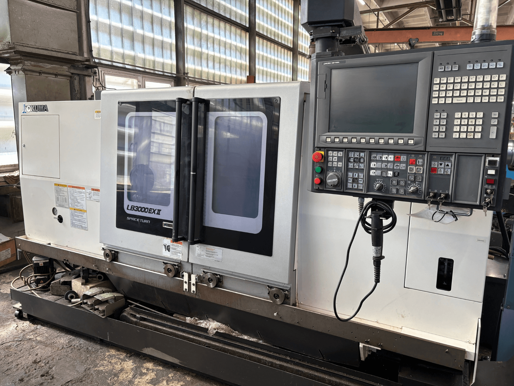 Okuma LB3000EXII horizontal turning machine, front view showcasing control panel and loading door.