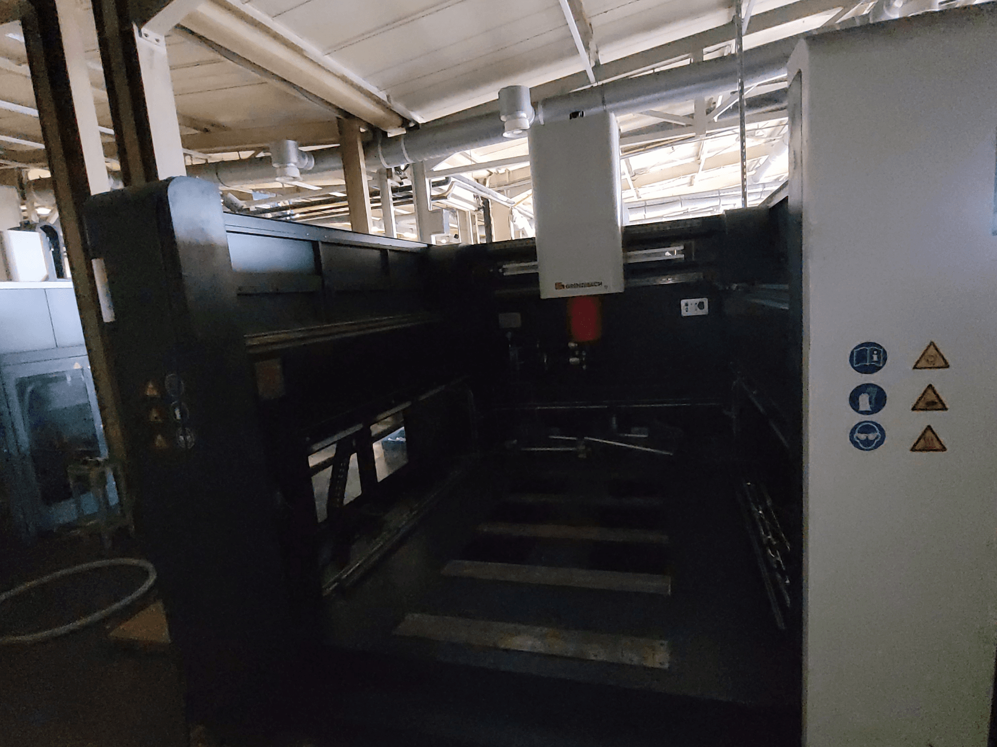 GRENZEBACH FSW Machine DSM 3000, side view showing controls, safety symbols, and workspace area for machining tasks.