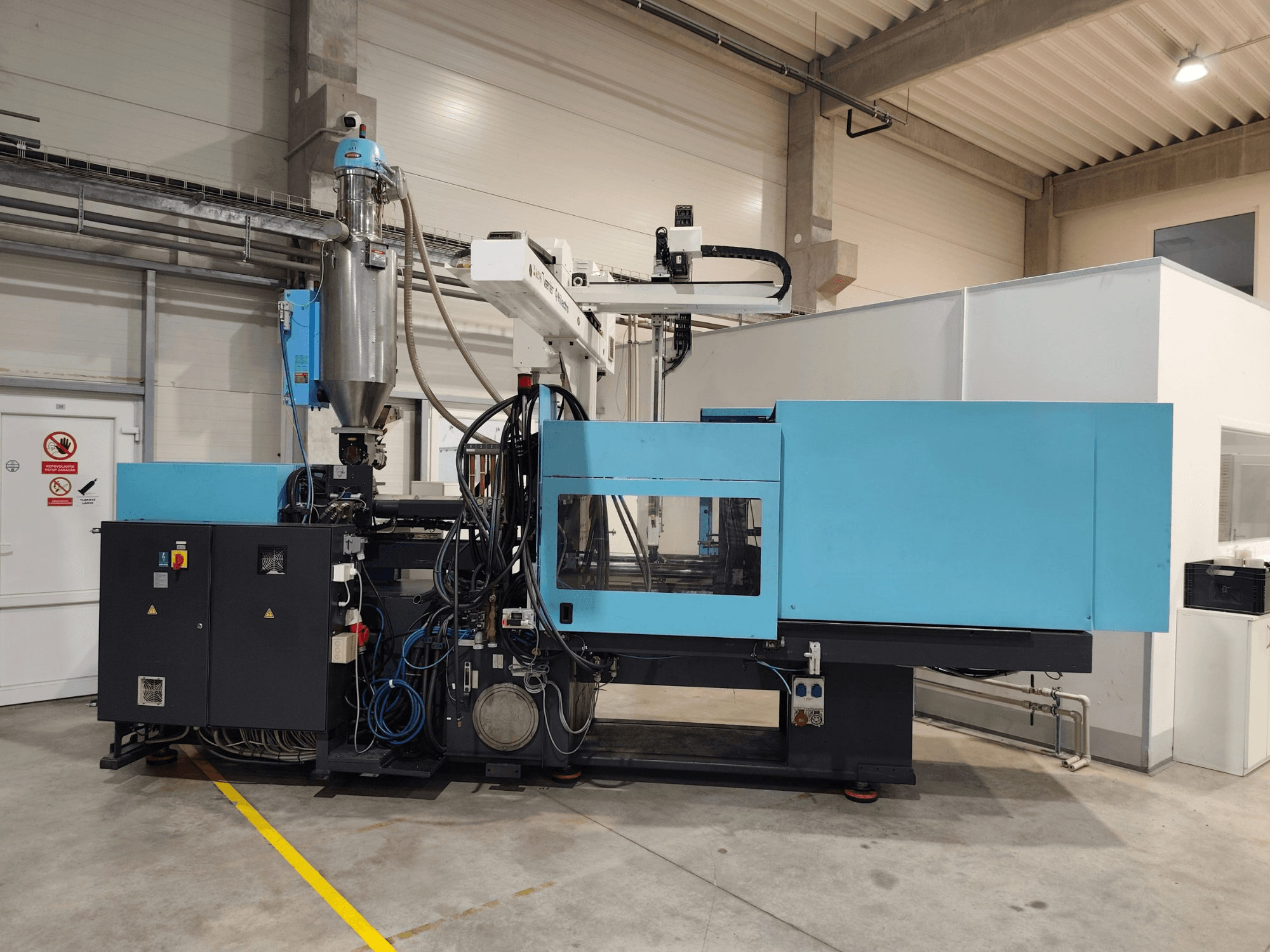 Front view of a DEMAG Ergotech Extra 160-430 hydraulic injection molding machine with visible control panel and hopper.