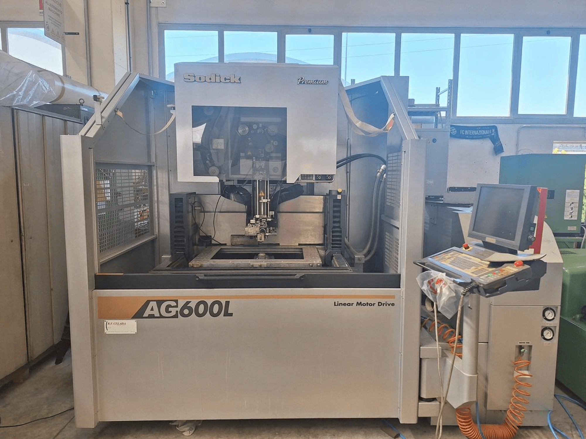 Sodick AG 600 L Wire EDM machine in front view, featuring a control panel and linear motor drive.