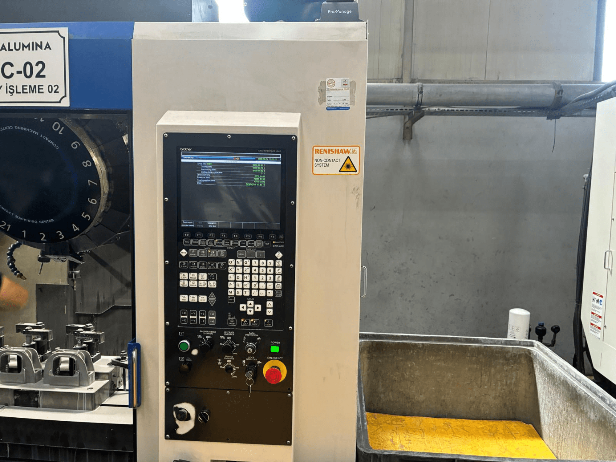 Brother S1000X1 vertical machining center, front view, showing control panel, tool holders, and a coolant collection tank.