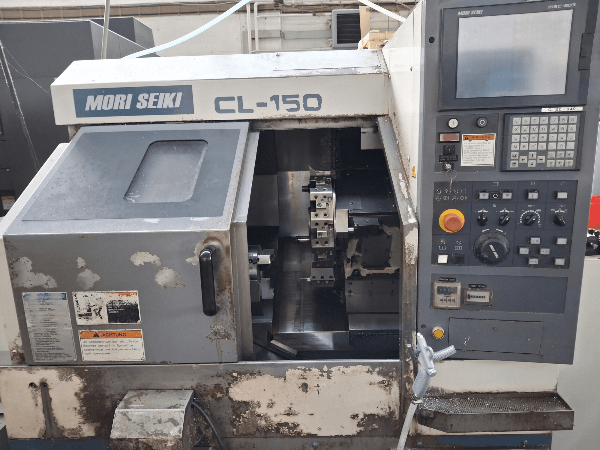 MORI SEIKI CL-150 horizontal turning machine, front view. Features control panel, cutting tools, and operational displays.