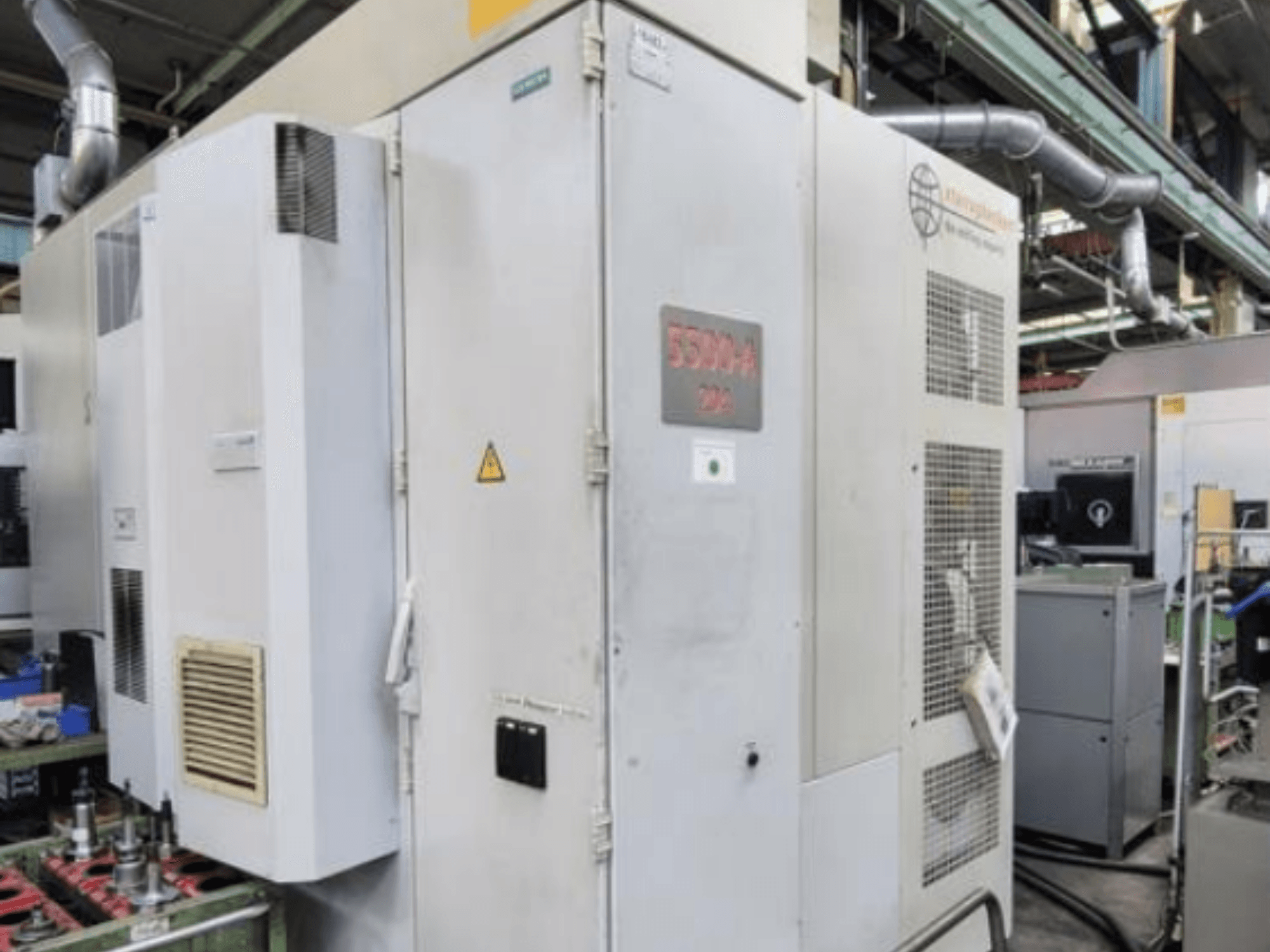 Starrag Heckert HEC 500 H/V horizontal machining center, side view showing exterior with vents and warning signage.