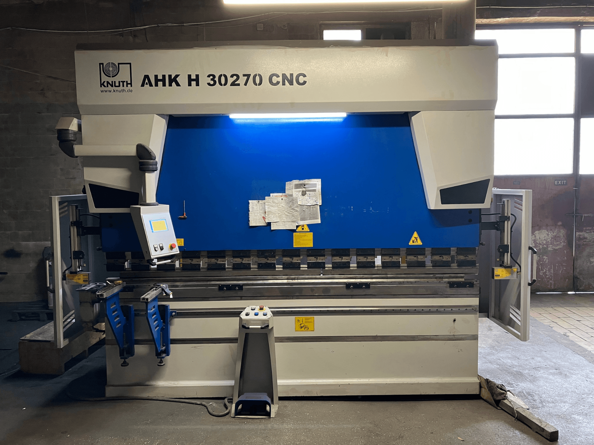 KNUTH AHK H 30270 CNC press brake in a workshop, front view, showcasing control panel and blue/white design, with open side door.
