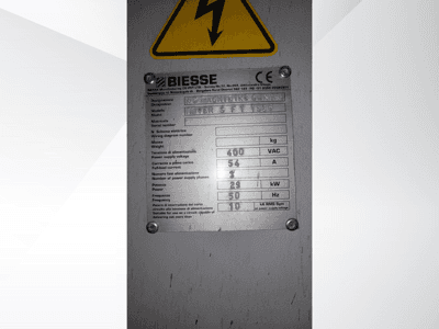 Biesse NC Machining Center technical specifications plate, displaying voltage, weight, and power details, side view.