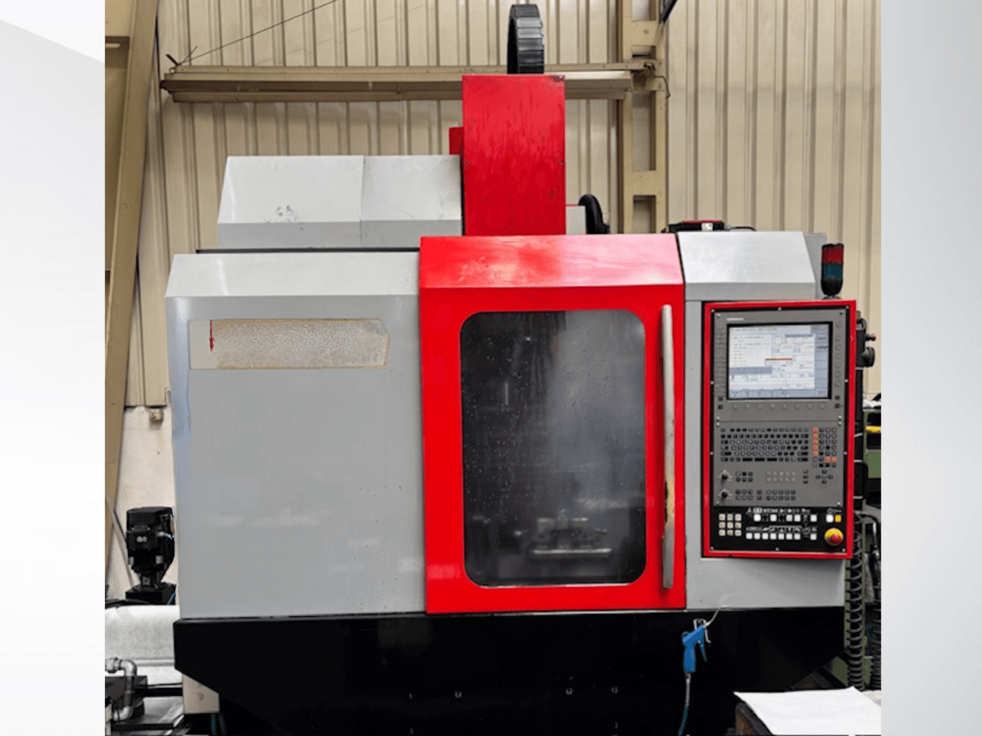 EMCO MC 75-50 vertical machining centre, front view, featuring a control panel with a screen and red accents.