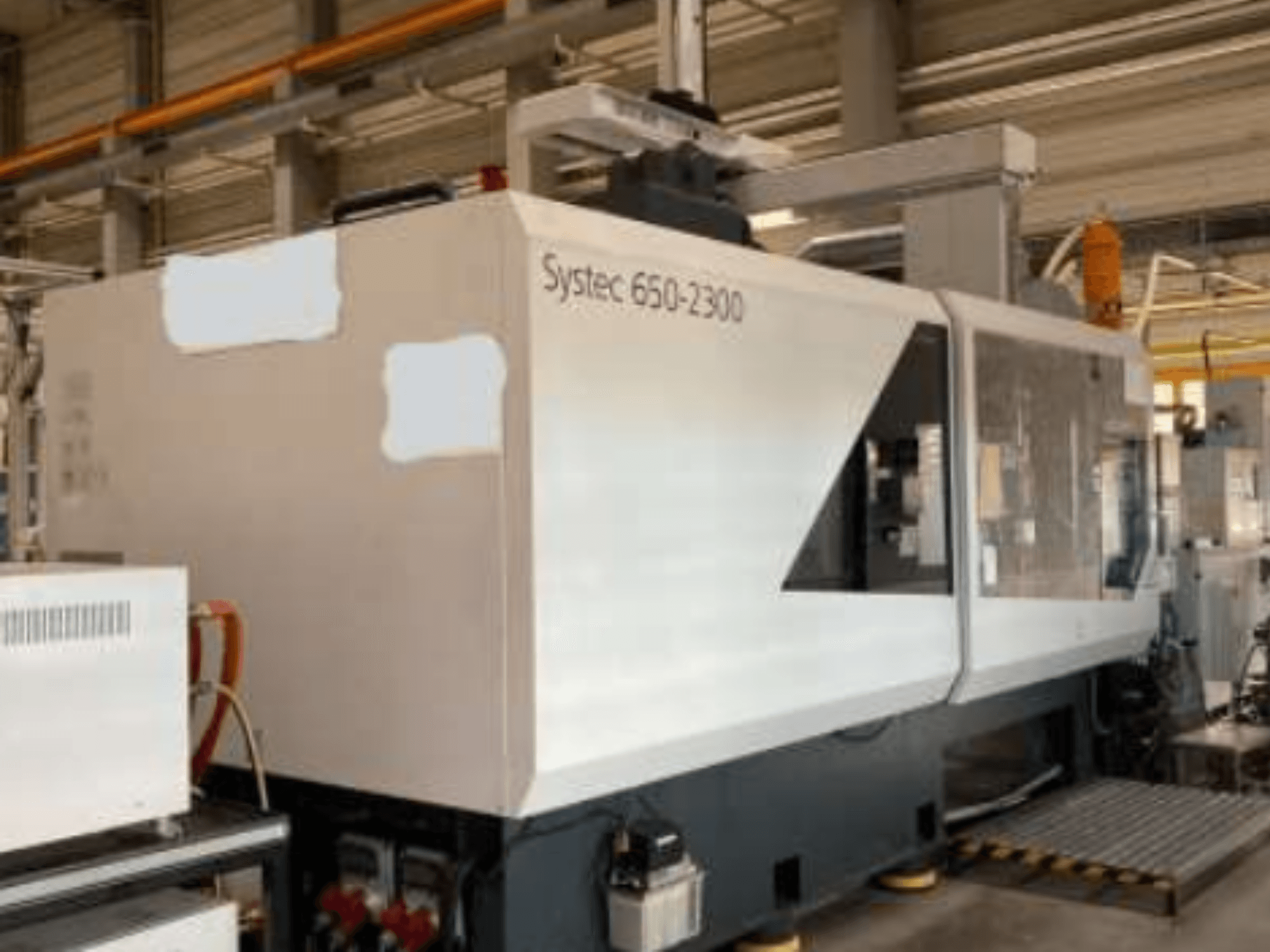 Systec 660-2300 machine, front view, showcasing large body, control panel, and safety loading platform, suitable for industrial use.