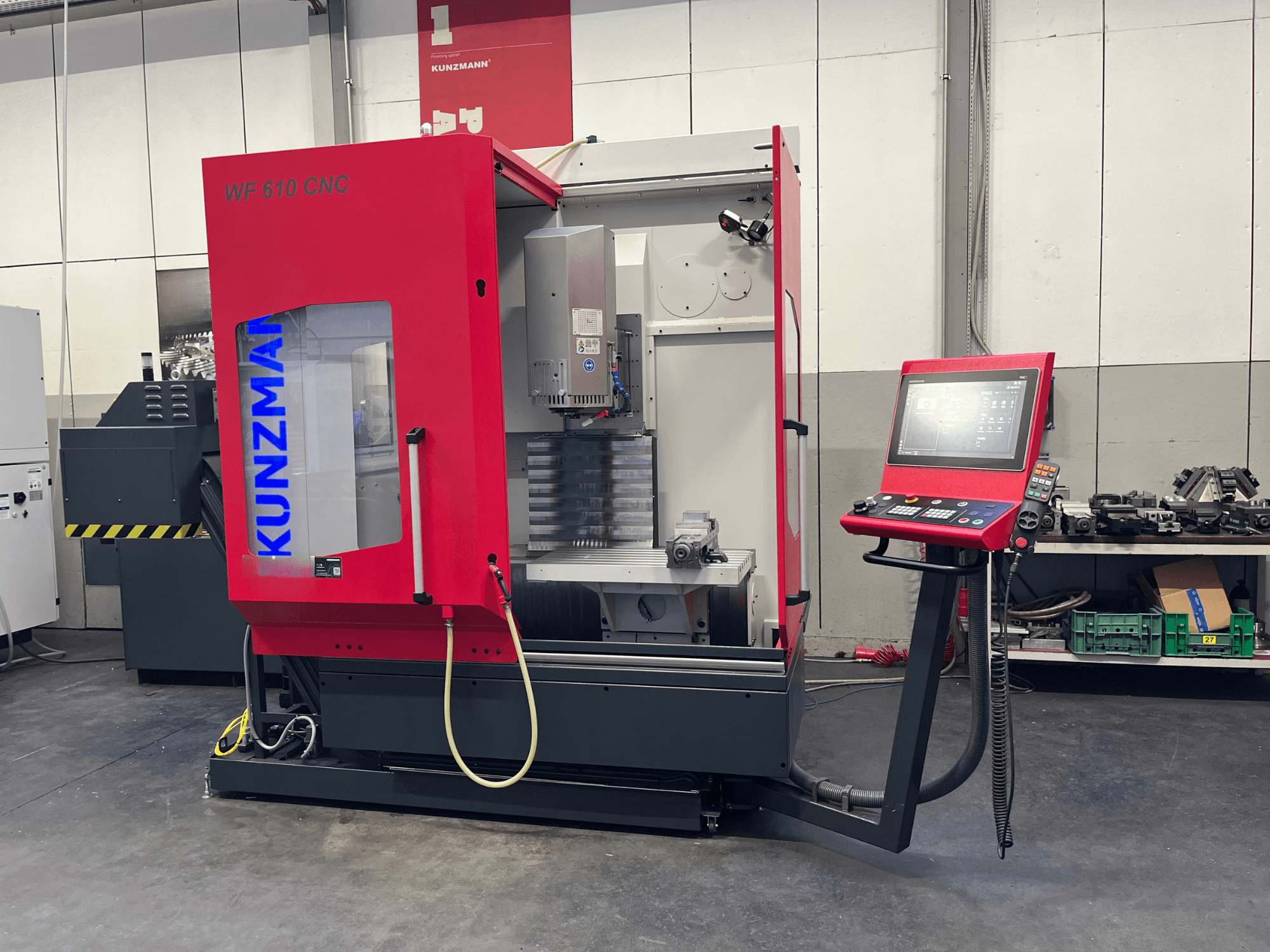 KUNZMANN WF 610 CNC vertical machining center in a workshop, featuring a control panel and visible machine components.