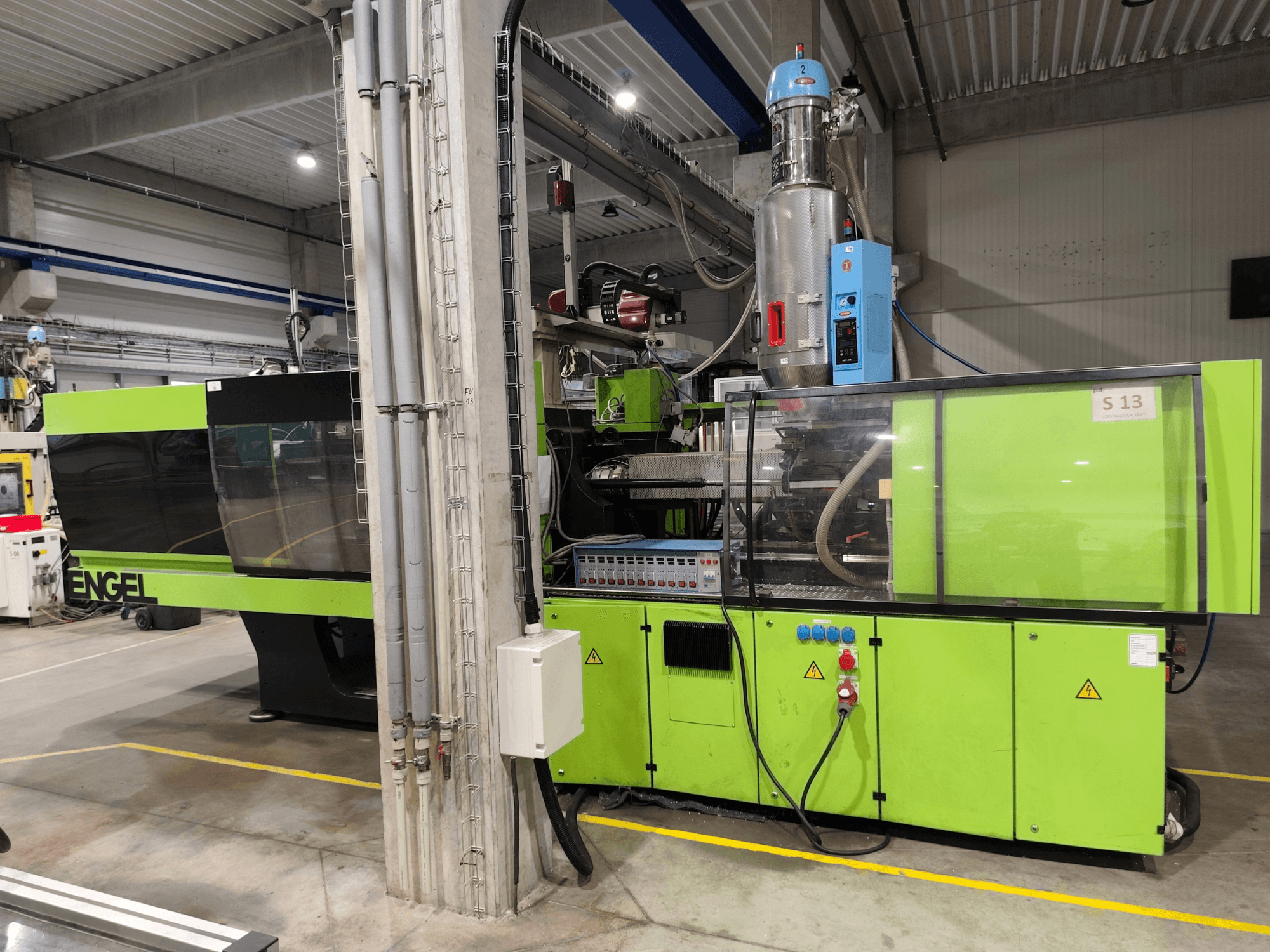 Engel Victory 750/180 hydraulic injection moulding machine, front view, featuring a green exterior and control panel details.