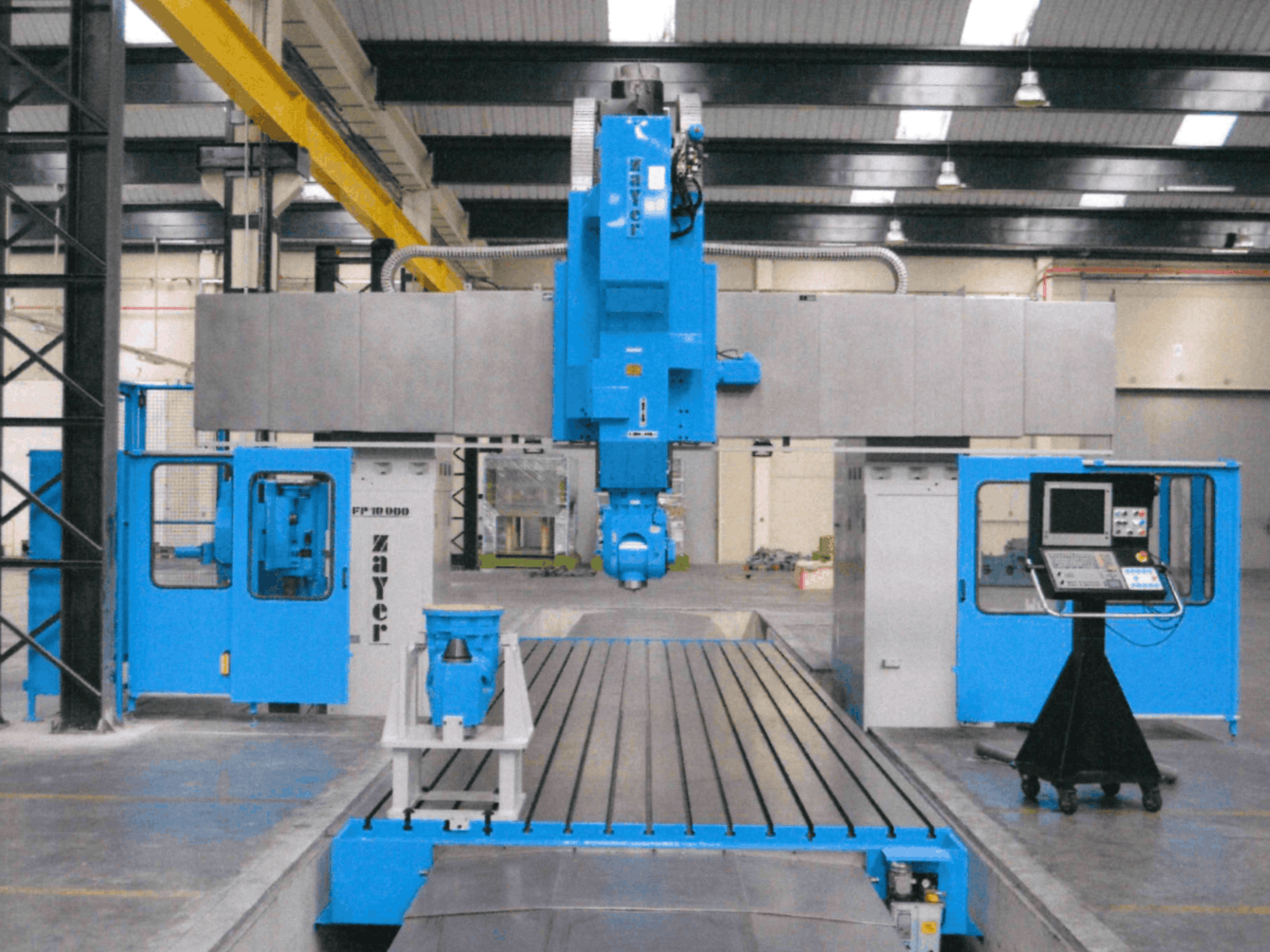Front view of Zayer FP-10000 bed type milling machine showcasing its blue structure, control panel, and precision components.