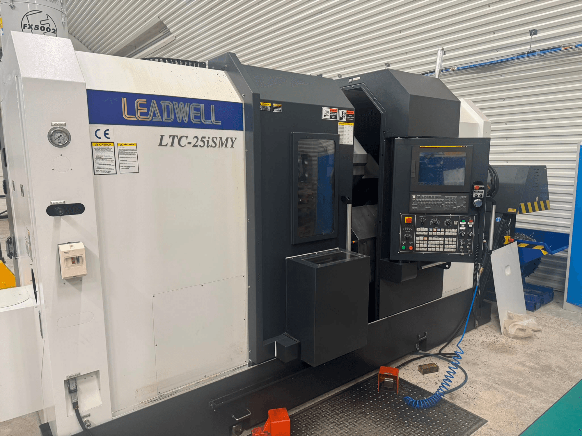 Leadwell LTC-25iSMY horizontal turning machine from a front view, showcasing control panel and operational interfaces.