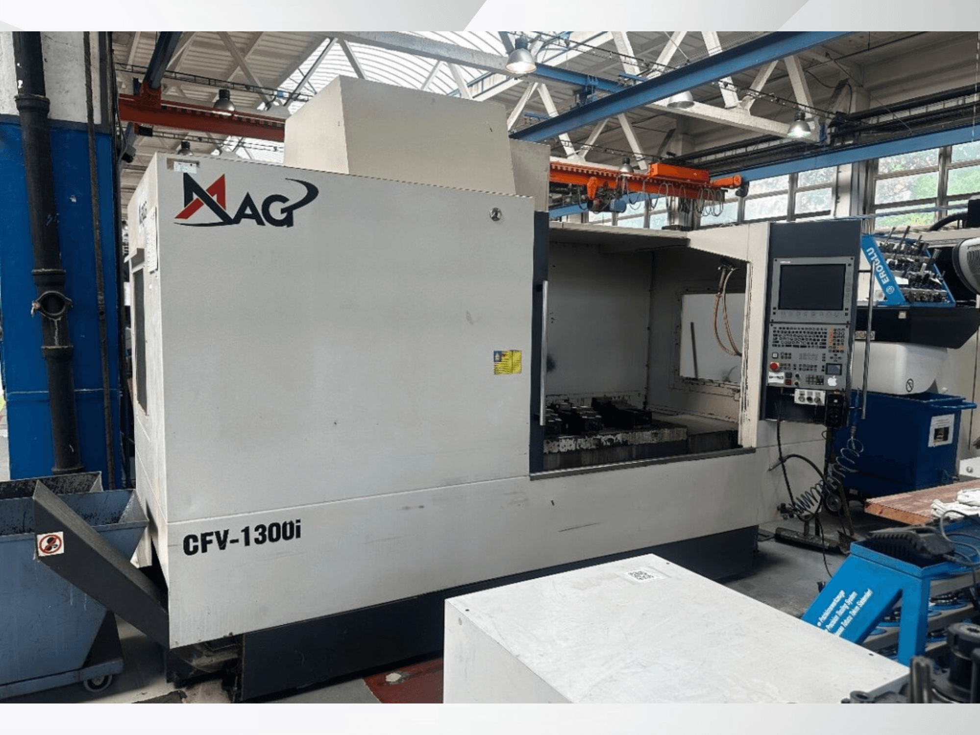 Cincinnati MAG CFV1300i vertical machining center in a workshop, front view showcasing control panel and machine interior.