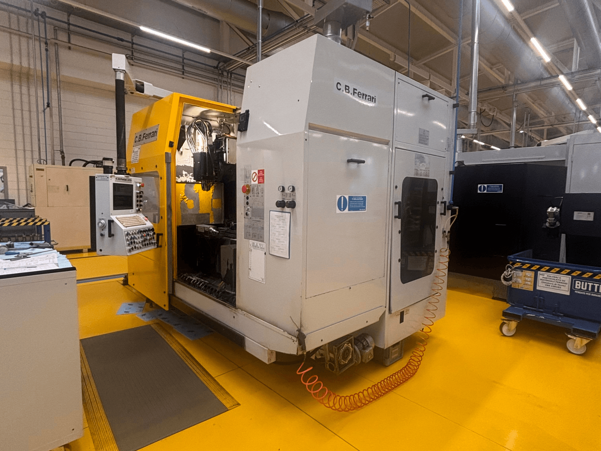 C.B. Ferrari A175 vertical machining center in a factory setting, front view with control panel and open access door visible.