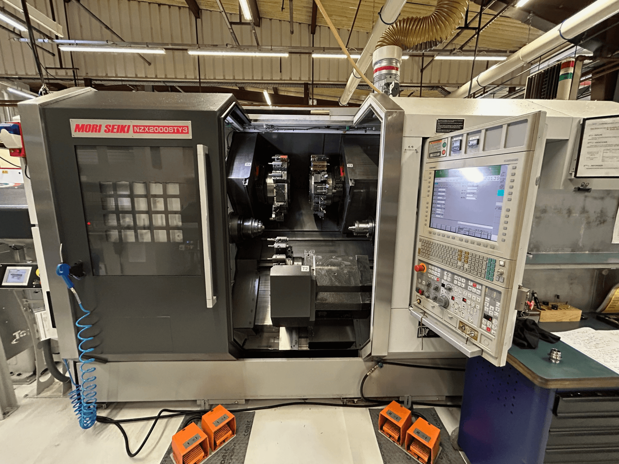 MORI SEIKI NZ2000 ST3Y3 multi-spindle turning machine, front view showcasing control panel and machining area.