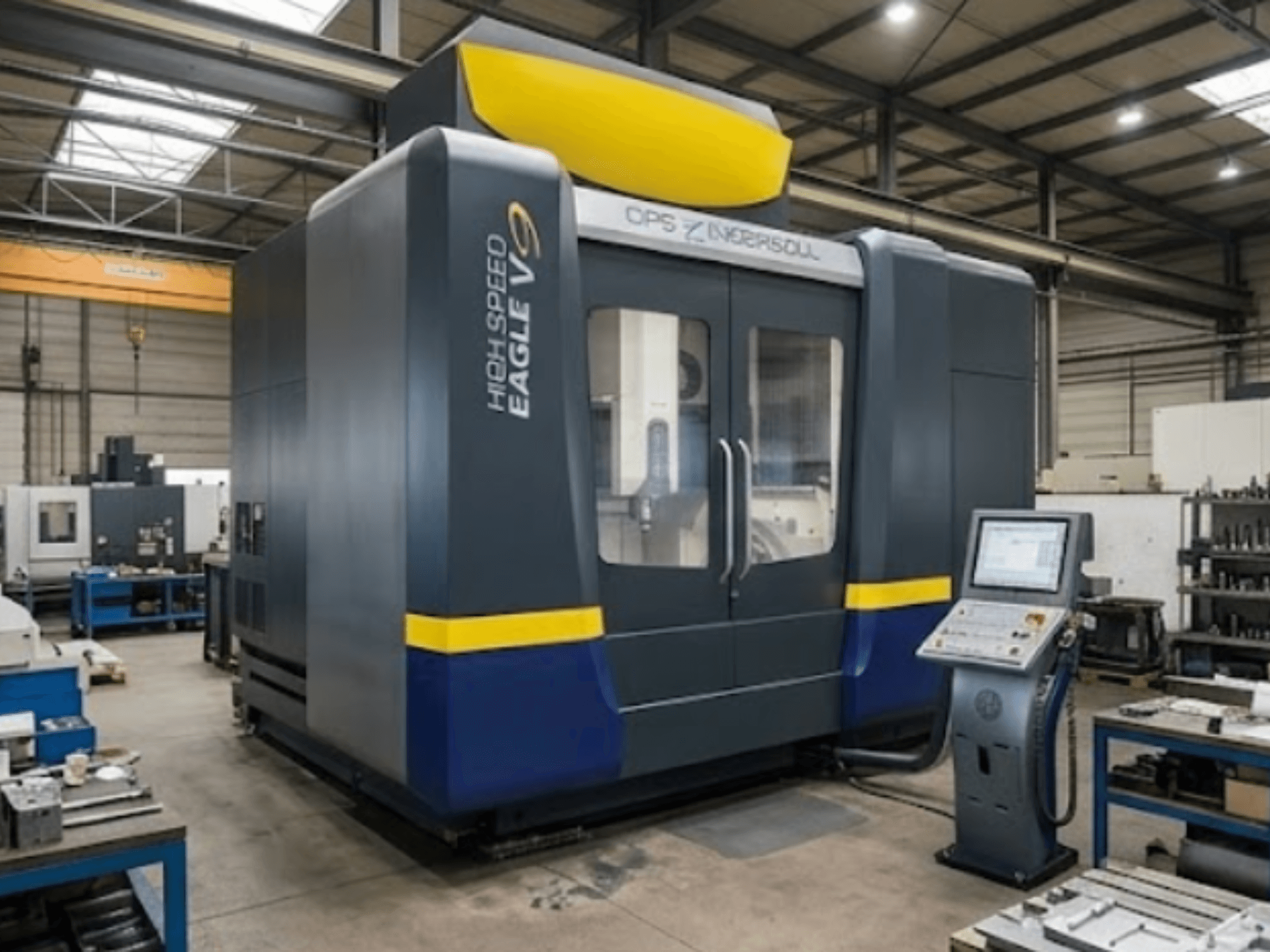 OPS INGERSOLL Eagle V9 vertical machining center in a workshop, front view, with control panel and tooling on nearby workbench.