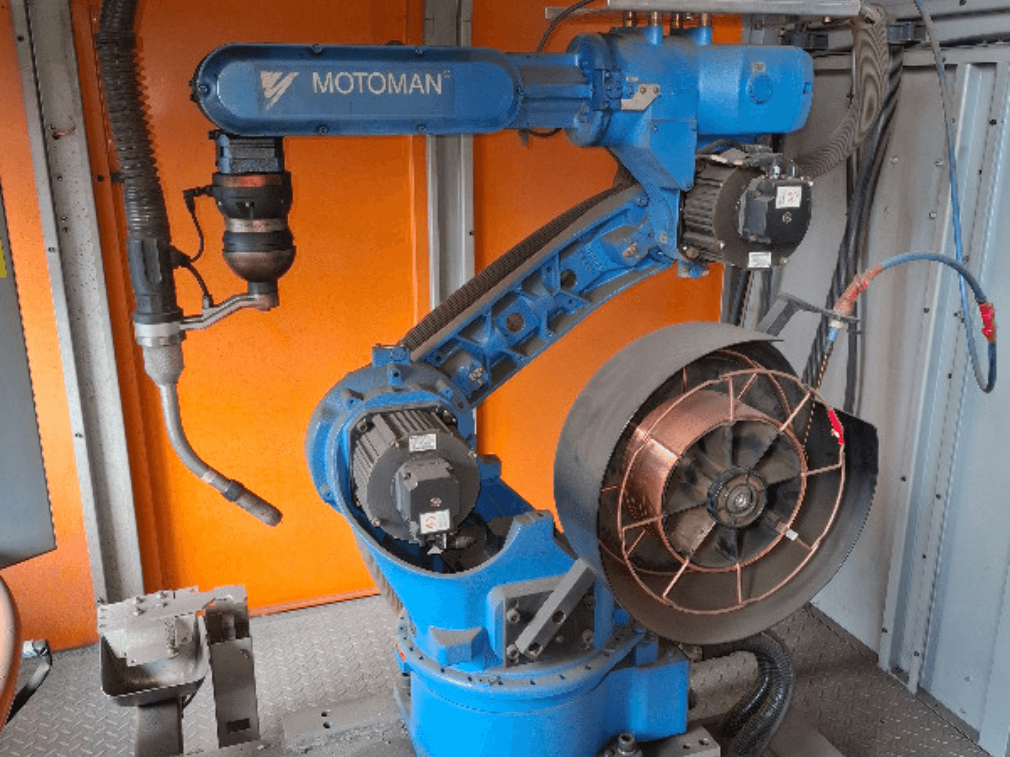 MOTOMAN robotic arm in blue, side view, with attached fan and tooling, displaying mechanical details and connections.