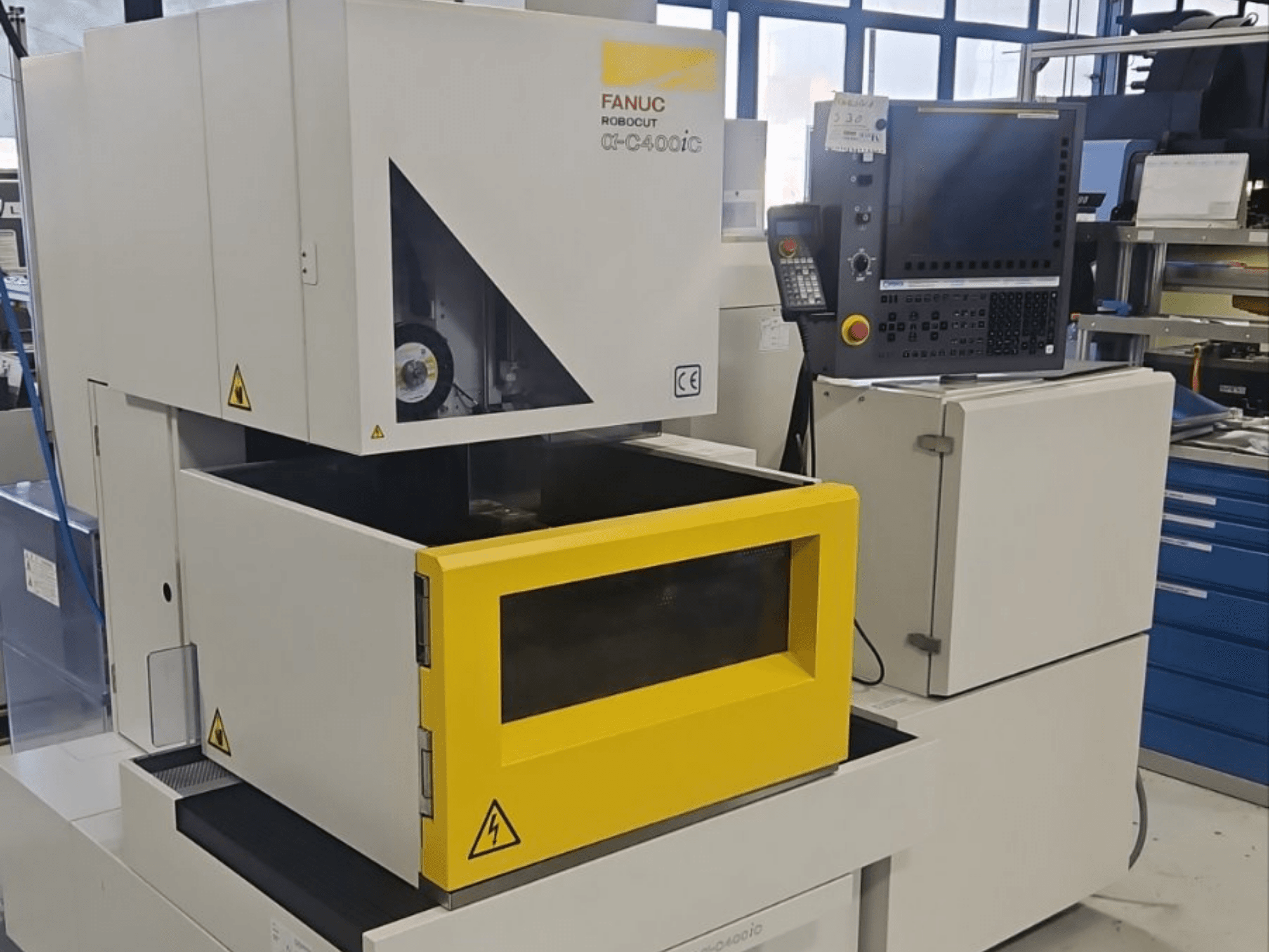 FANUC Robocut alpha-C400iC die-sinking EDM machine in front view, featuring a yellow workpiece chamber and control panel.