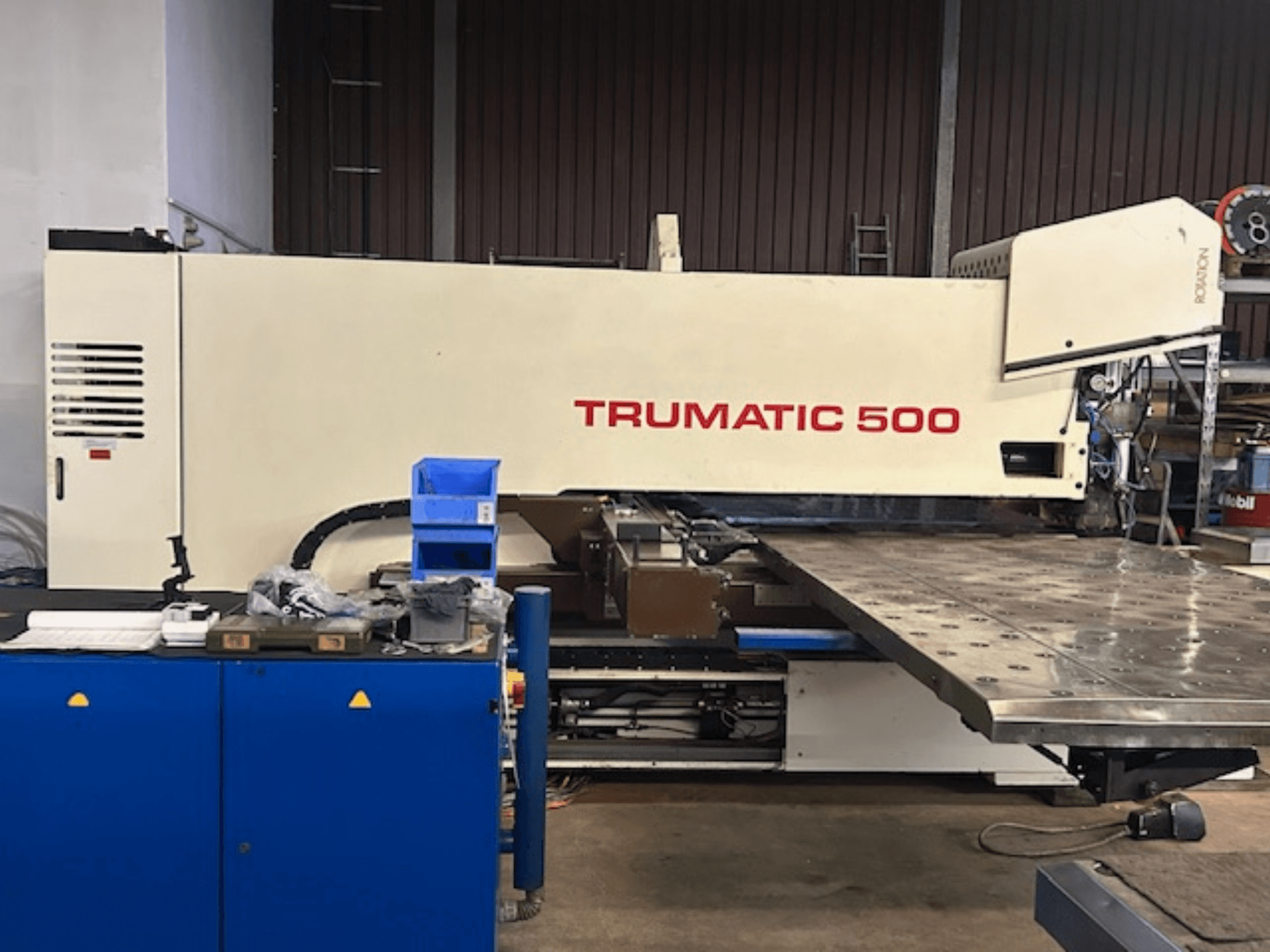 TRUMPF TRUMATIC 500 CNC punching machine, front view, with control panel and a large worktable displaying perforated surface.