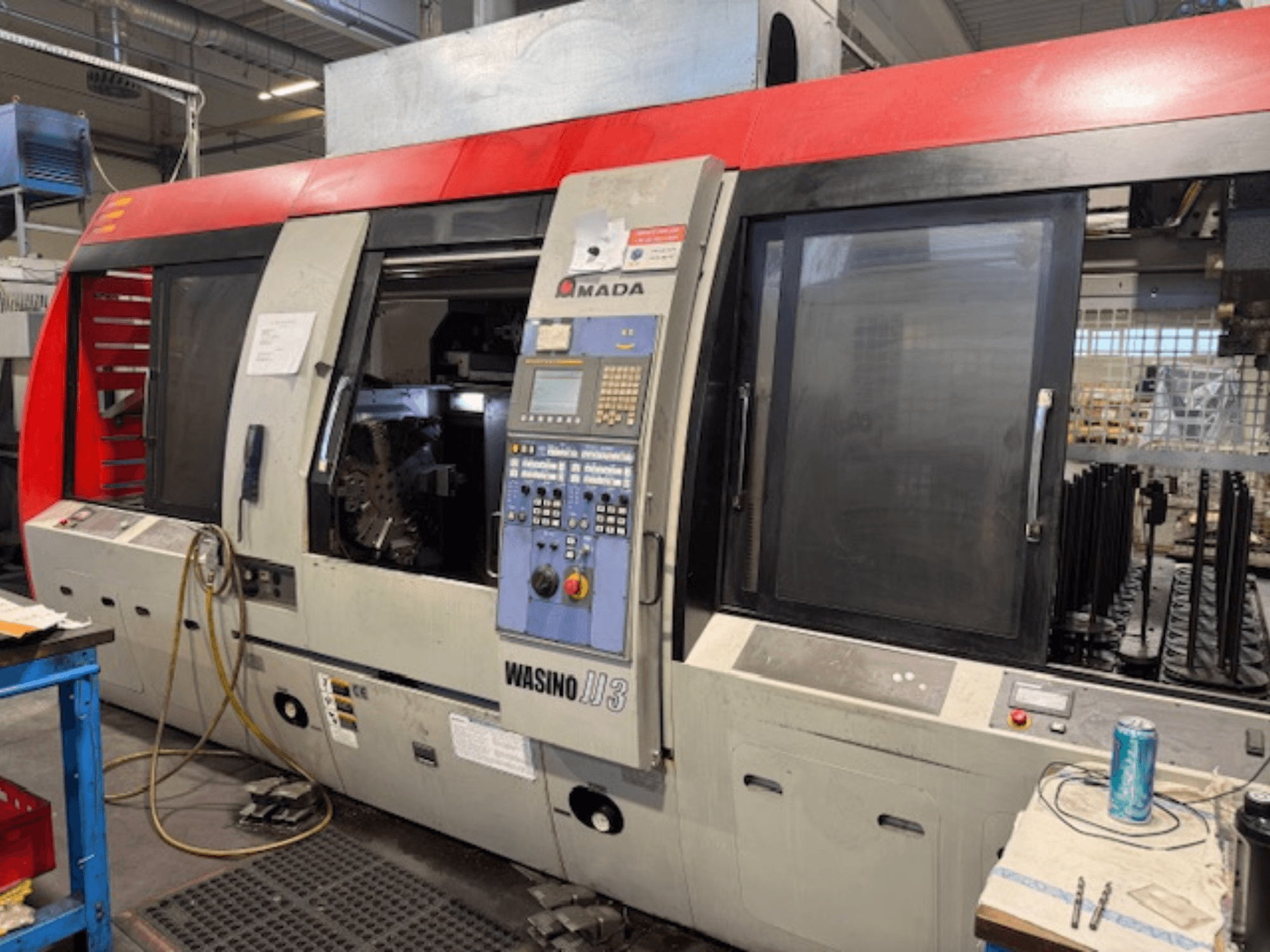 AMADA Wasino JJ3 horizontal turning machine, front view showcasing control panel and open chamber for machining.