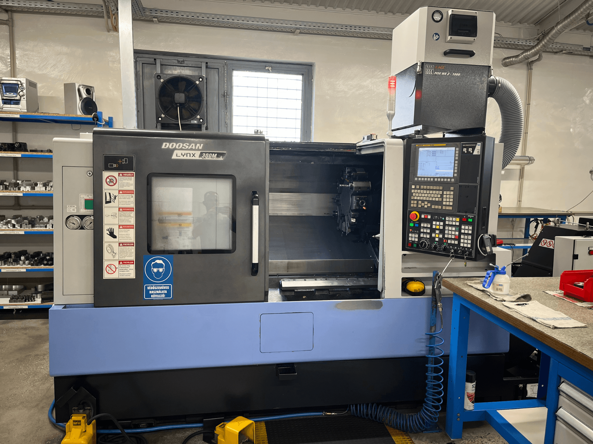 DOOSAN LYNX 300M horizontal turning machine, front view, featuring control panel and operational components.